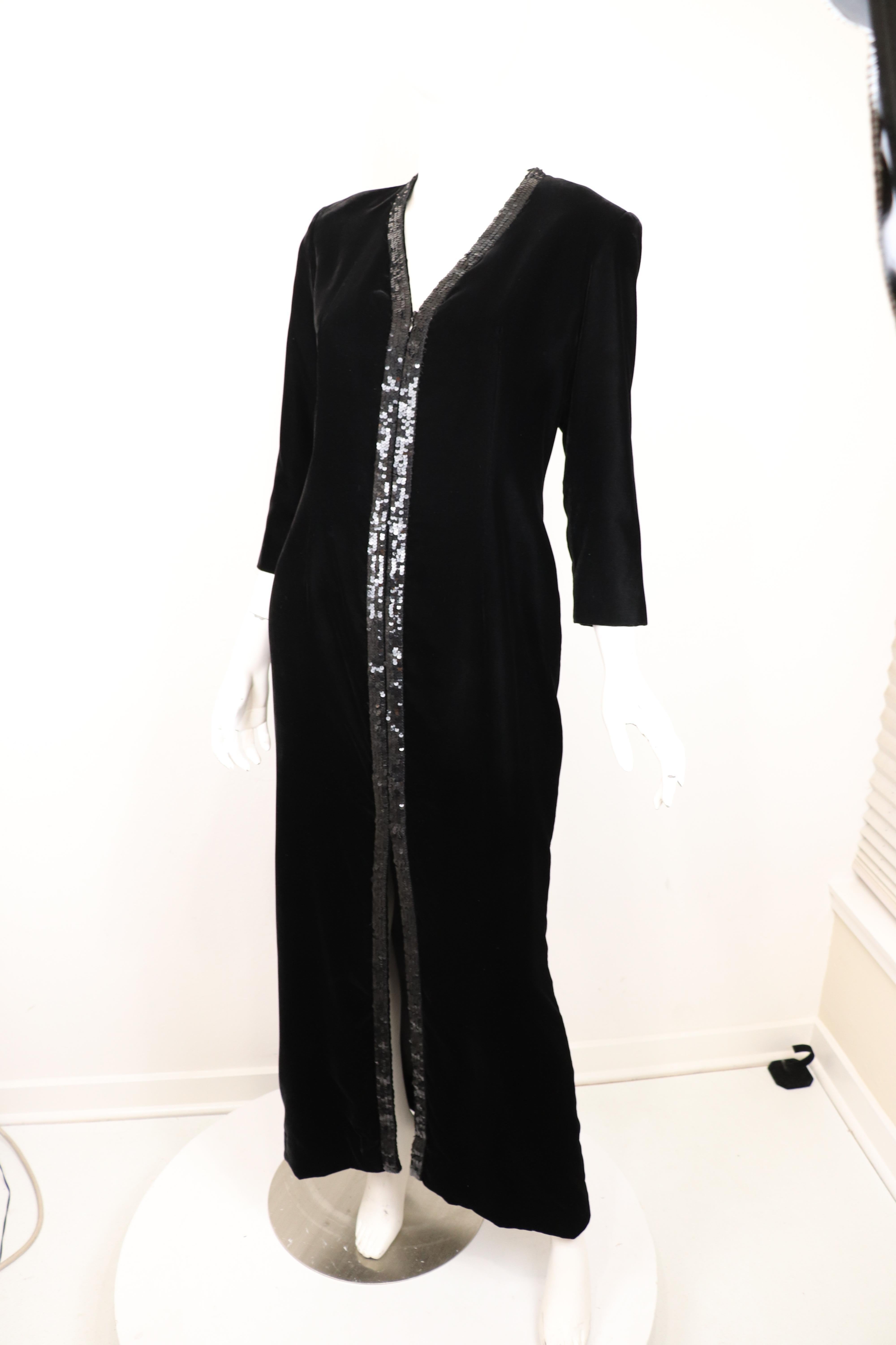 This luxurious Yves Saint Laurent Rive Gauche vintage column gown showcases a soft black velvet with 3/4 length sleeves and a black sequins trim that extends from the neckline, alongside the front zipper, to the front slit. Zipper unzips to about