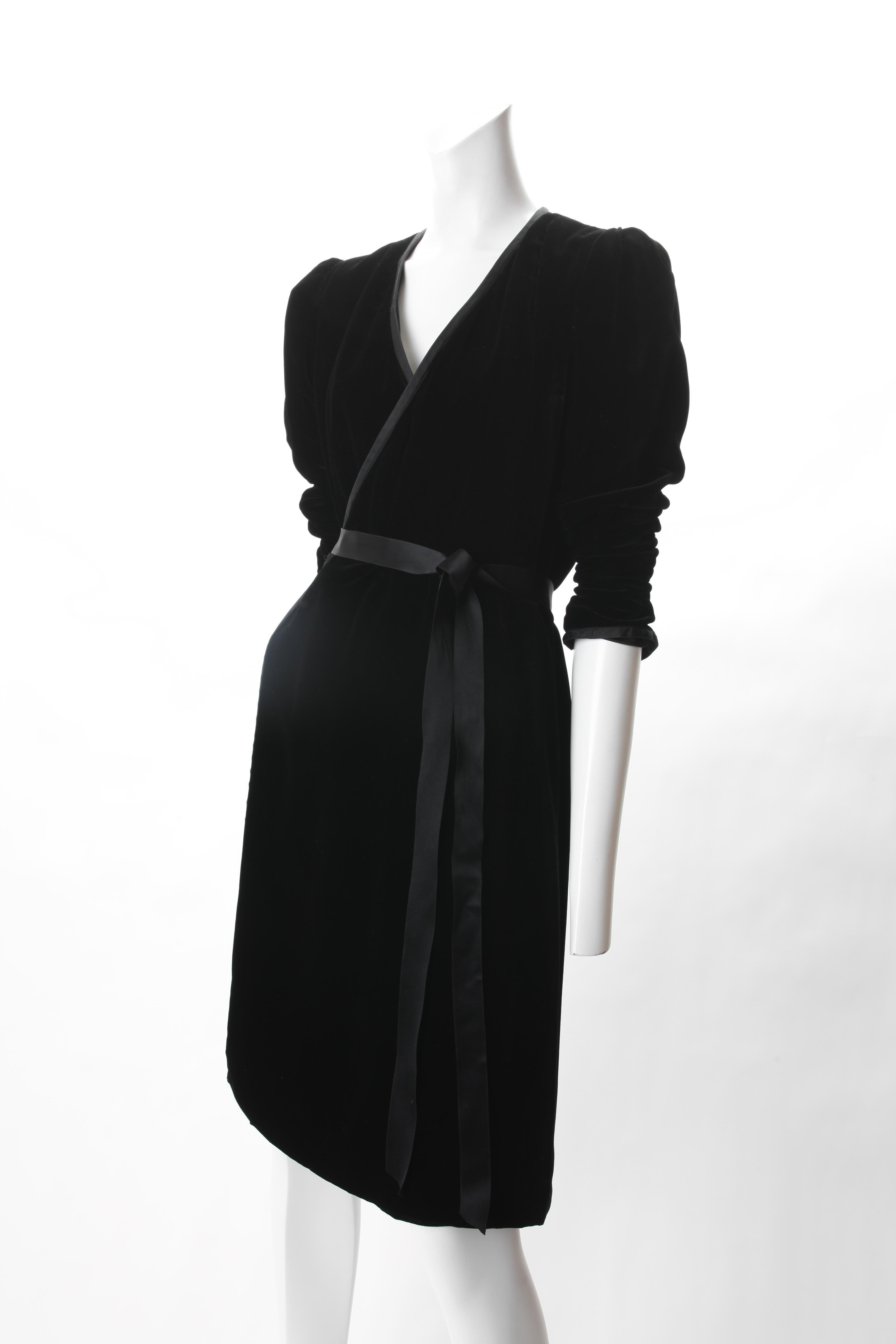 Yves Saint Laurent Rive Gauche Black Velvet Wrap Dress. c.1980s.
Yves Saint Laurent Black Velvet Wrap Dress featuring Grosgrain piping border all around and at cuff of puff sleeve. Silk lined with silk self tie closure at waist.

Marked Size EU