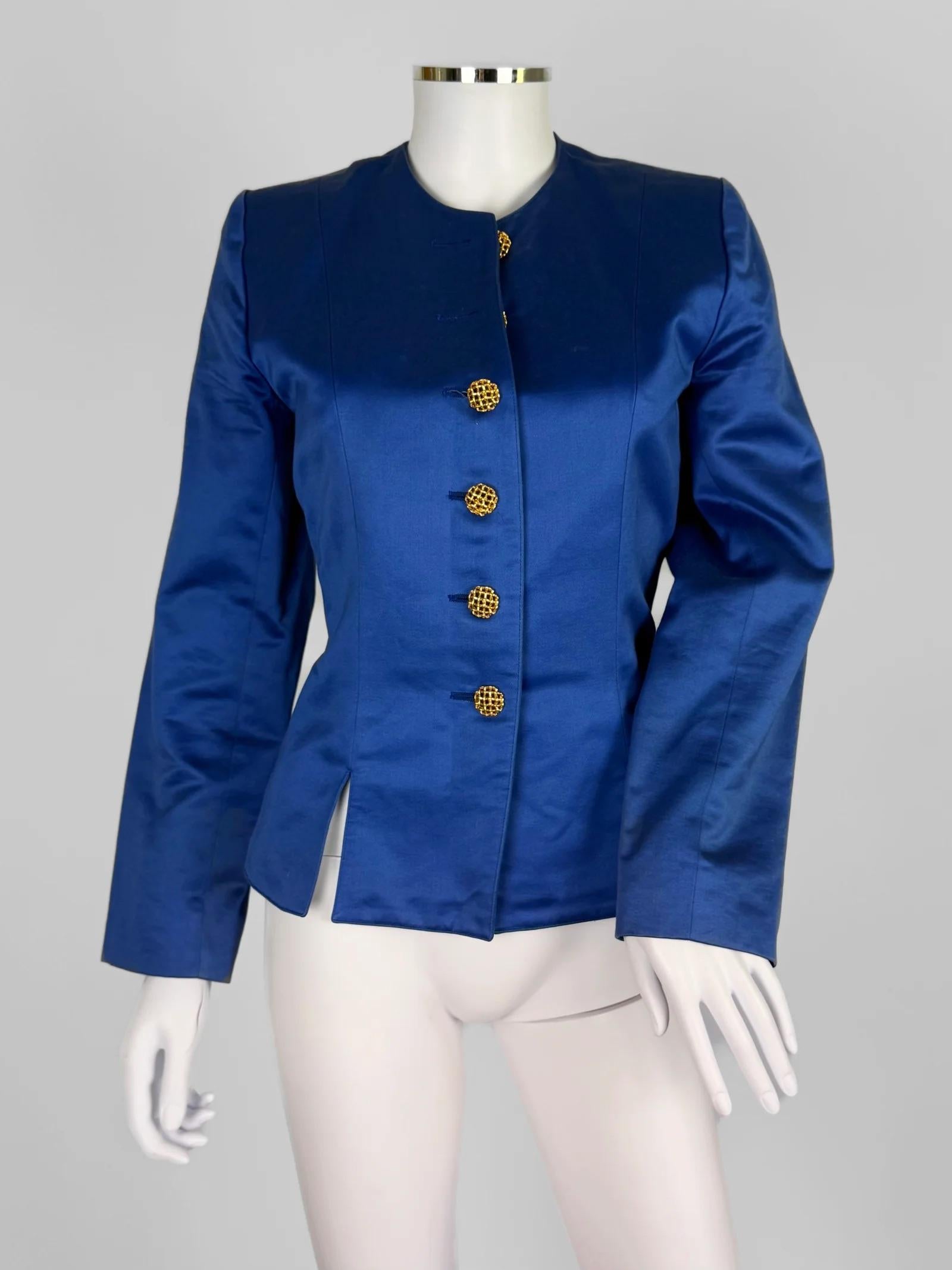 Yves Saint Laurent Rive Gauche cotton satin jacket, circa late 1980s
Cobalt blue
Clean silhouette with a collarless design, strong shoulders, and a fitted waist that flares slightly into sculptural side slits
Does up with gold-toned lattice buttons