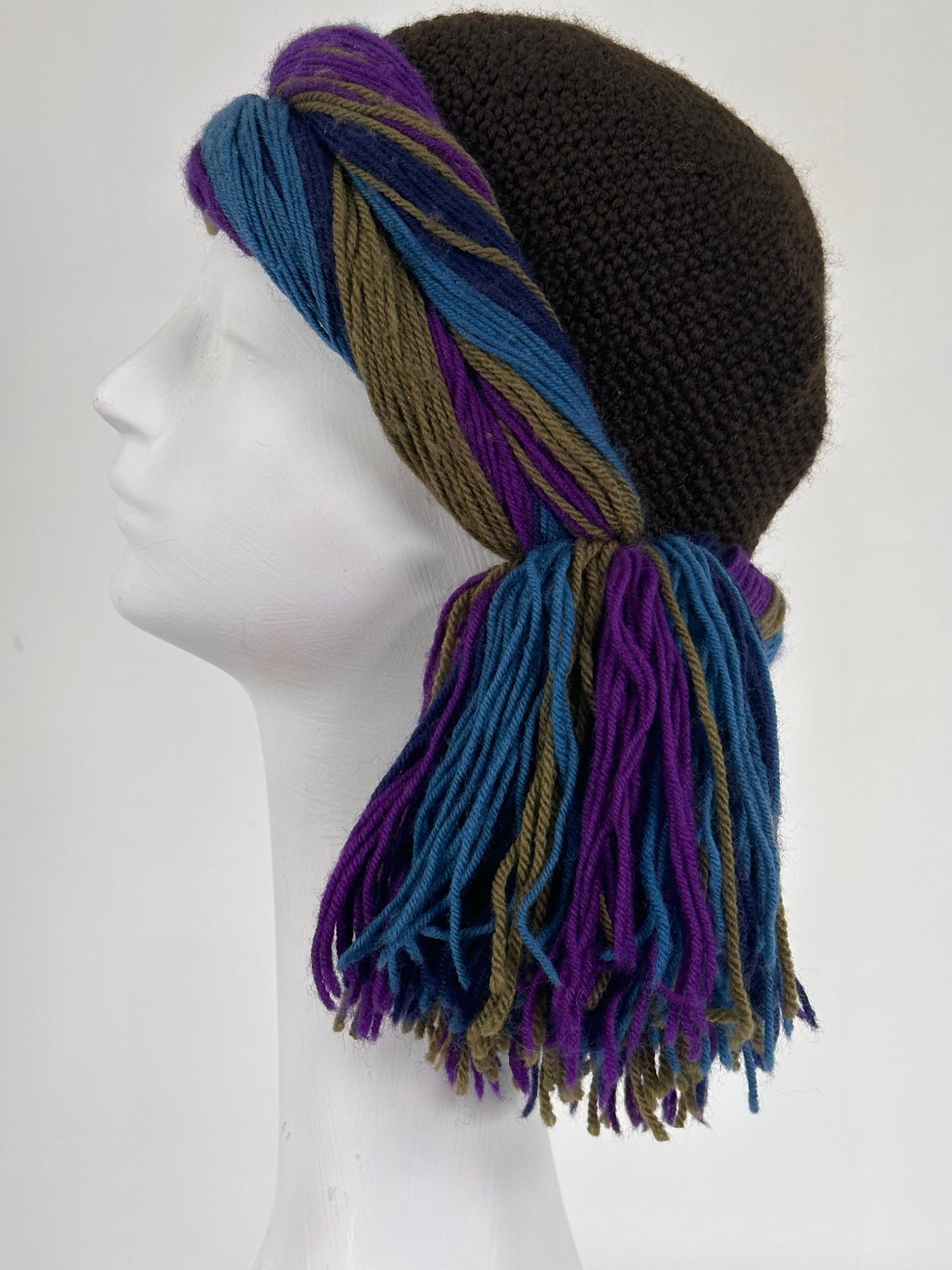 Rare 1970s Yves Saint Laurent Rive Gauche crochet cloche braid band & tassel in brown, the wool. Braid is purple, navy, blue & olive green. Fitted cloche cap has some stretch. Unlined. 
20
