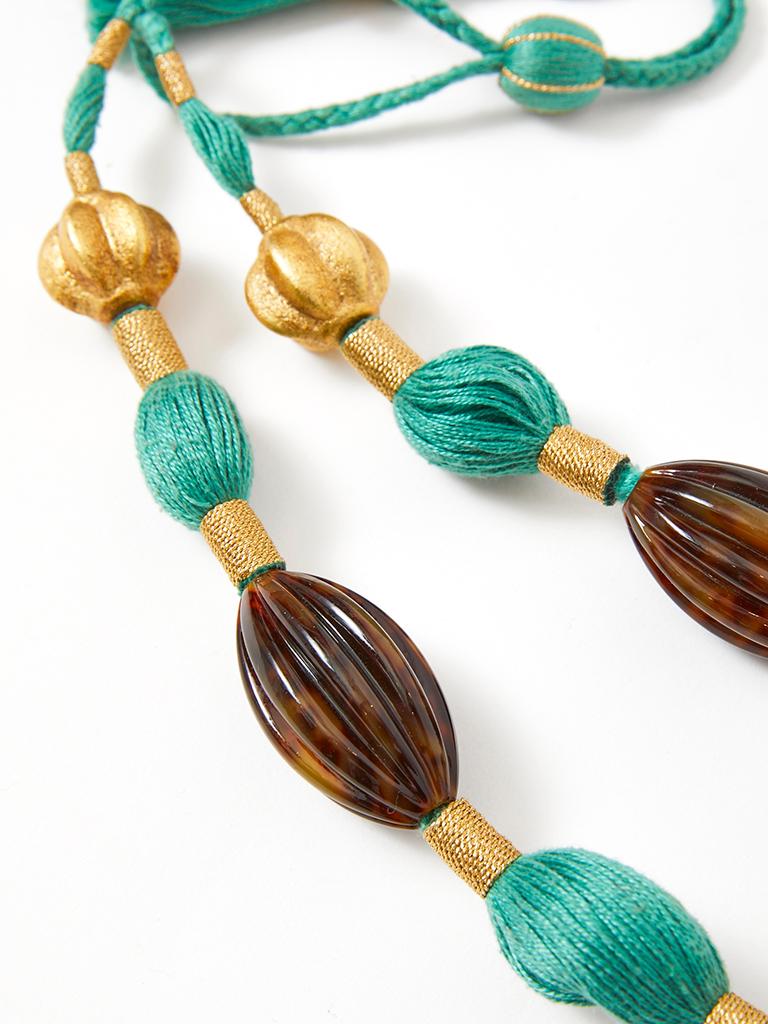 Yves Saint Laurent, Rive Gauche, pendent necklace,  strung on turquoise corded threads with chunks of faux tortoise lucite and fluted gold leaf beads. Tassel closure detail.