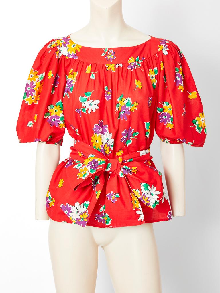 Yves Saint Laurent, Rive Gauche, red cotton, floral peasant ensemble, c. 1970's. Smocked top has full, balloon sleeves that end at the elbow with elastic. Skirt has a purple stitched yoke and with full gathering at the upper hip. Ensemble comes with