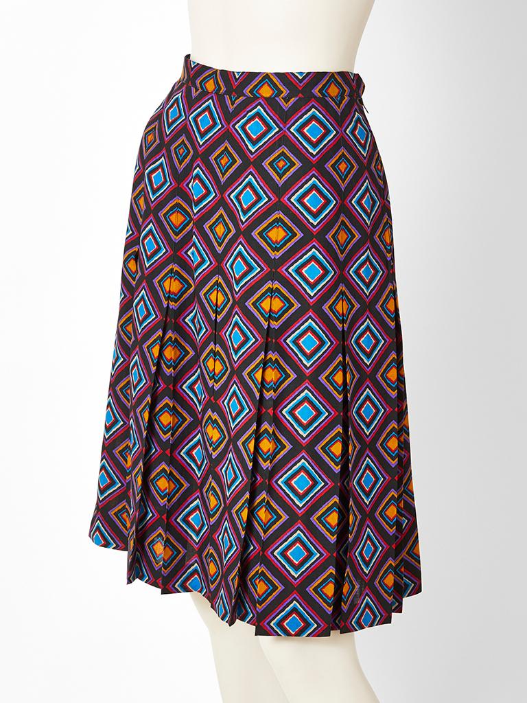 Yves Saint Laurent, Rive Gauche, multi tone, wool challis, geometric pattern skirt. Skirt has box pleats that start at the hip. Pleats are stitched down at the waist and hip.
Designer : 

