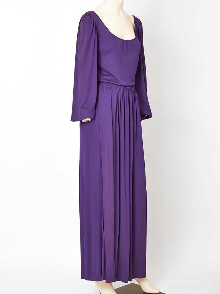 Yves Saint Laurent, Rive Gauche, purple, classic, matte jersey, gown having a scoop neckline, full sleeves that have elastic at the wrist, and a gathered long skirt. Bodice drapes slightly at the waist.
C. 1970's. 