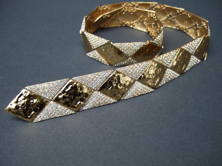 YVES SAINT LAURENT Rive Gauche Paris Opulent articulated gilt metal crystal couture belt c 1970s
The exquisite rare Saint Laurent couture belt is designed with heavy gilt metal articulated geometric panels 
that have a textured finish. Juxtaposed