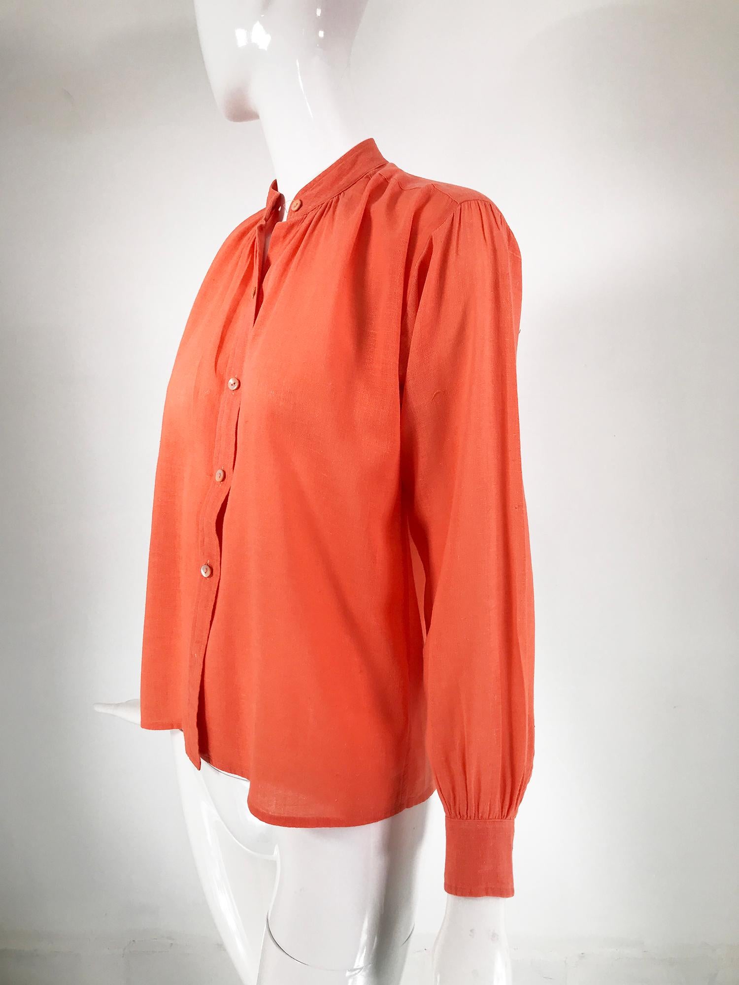 Yves Saint Laurent Rive Gauche orange cotton gauze bouse from the 1960s. Classic Yves Saint Laurent blouse has a band collar, shoulder yoke front and back with slight gathers, under arm gussets. Long sleeves with band buttons cuffs. The blouse