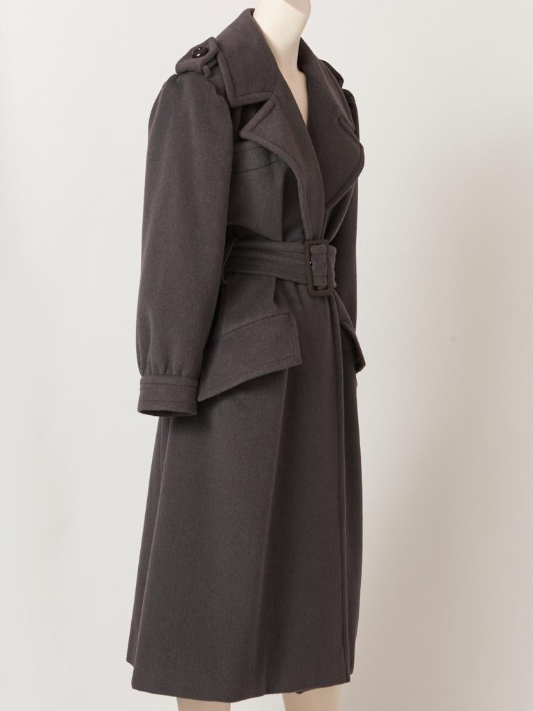 Yves Saint Laurent, RIve Gauche, wool, 1980's oversize belted coat, in a charcoal grey tone, having large lapels with slanted flap pockets .  Shoulders have epaulettes and the sleeve cuff is slightly gathered. Details of this piece are all in