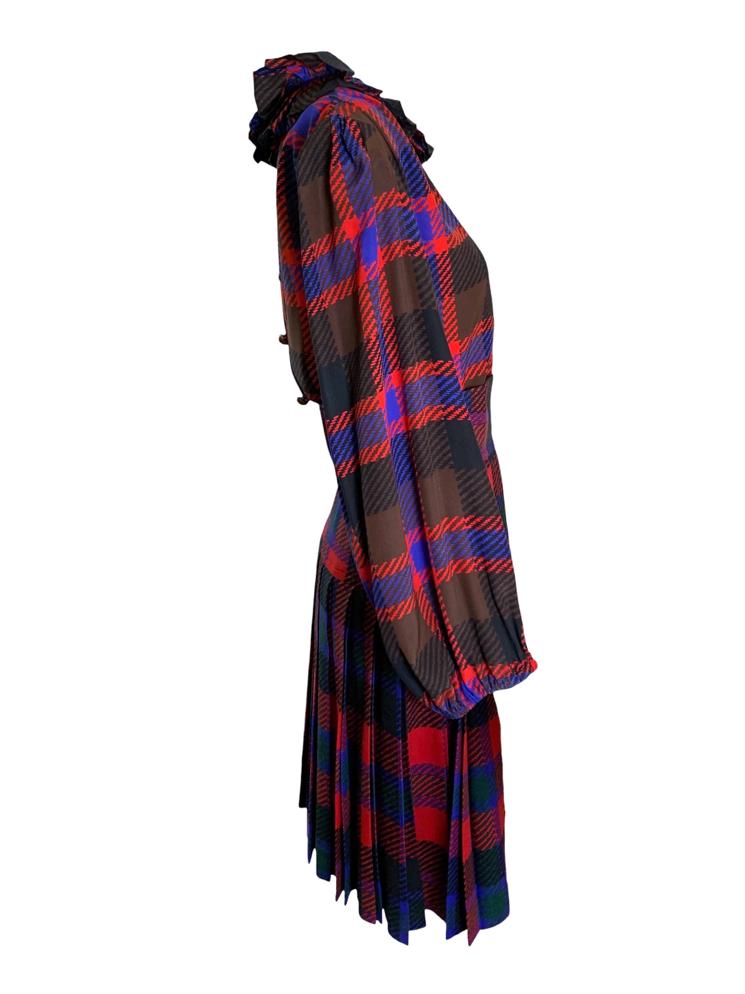 Sweet as can be plaid ensemble by Yves Saint Laurent. Circa late 70's/ early 80's. Bishop sleeve silk blouse with a ruffled collar and back button-up closure. The skirt is a matching plaid in a smooth wool. The skirt is high waisted with pleats