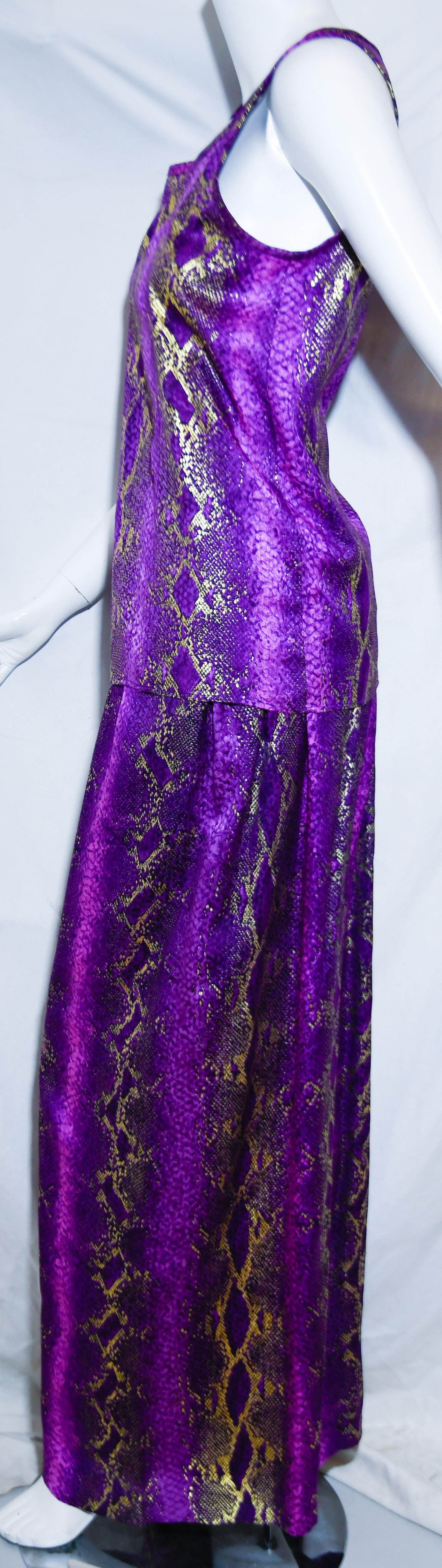 Yves Saint Laurent Rive Gauche purple and metallic gold snake print  2 piece pant set incorporates a sleeveless scoop neck top and a palazzo style wide slacks.  This striking ensemble is beautifully designed and created with the best purple silk
