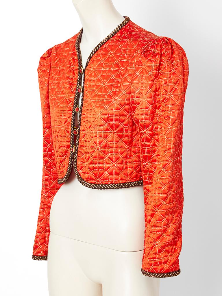 Yves Saint Laurent, Rive Gauche, orange, cropped jacket, having a geometric quilted pattern in gold lamè. Gold braided trim embellishes the the edges. Fabric is a viscose Satin.
