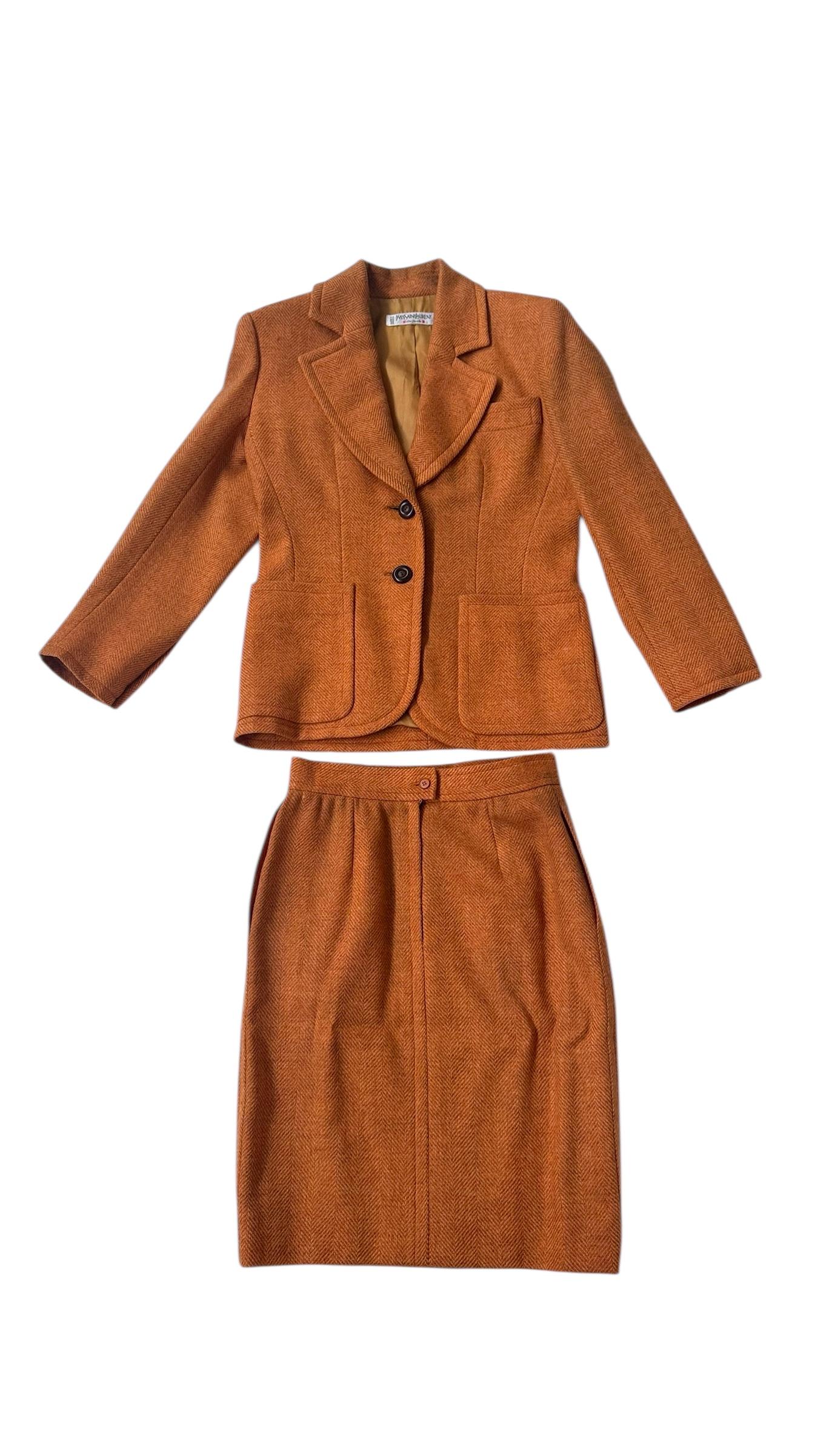A refined vintage two-piece skirt suit by Yves Saint Laurent Rive Gauche, dating to the late 1970s or early 1980s. This ensemble is a beautiful example of YSL's mastery in transforming masculine tailoring into elegant and empowering