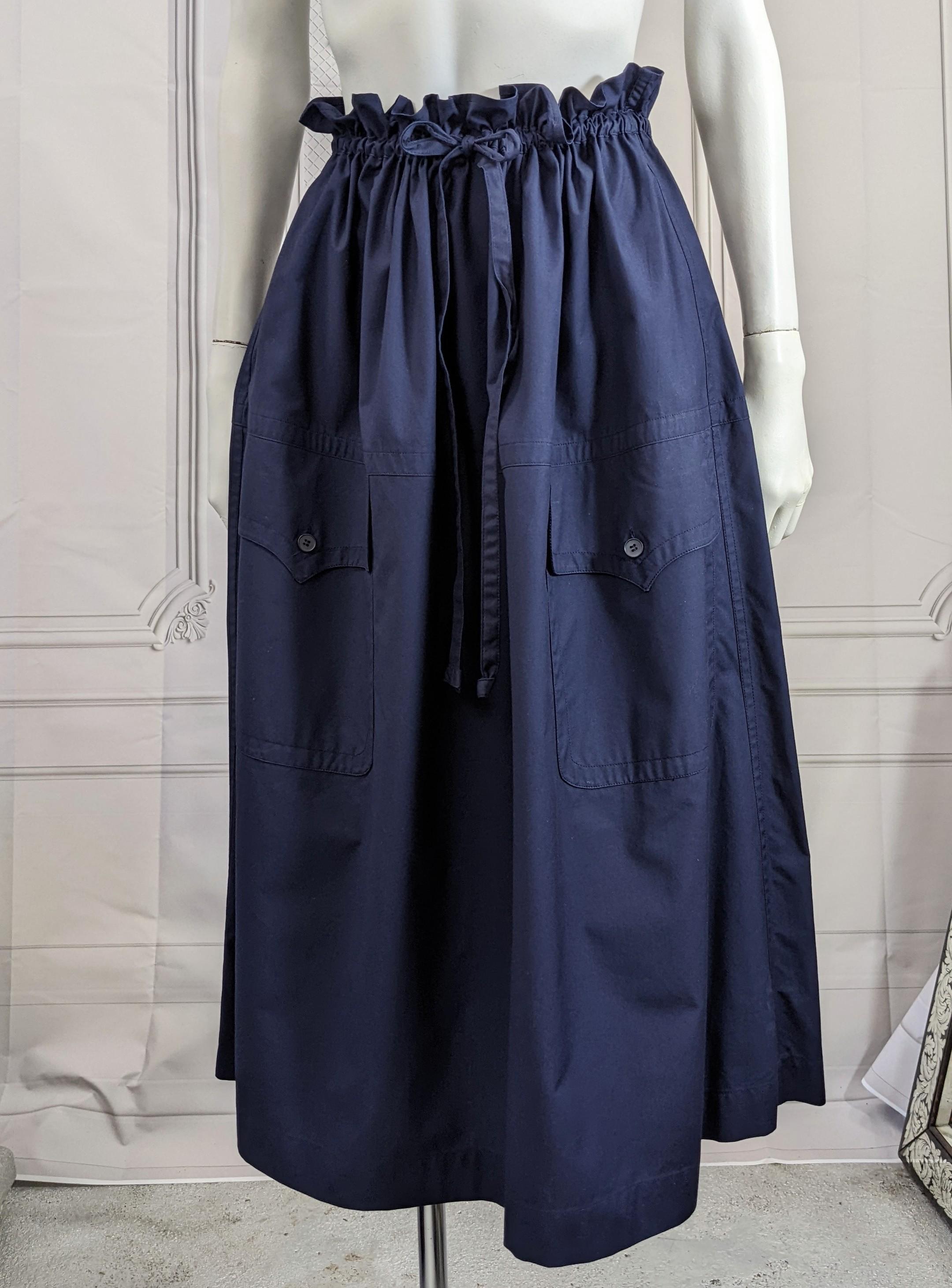 Iconic Yves Saint Laurent Rive Gauche Safari Skirt in crisp navy poplin from the 1980's. Self drawstring waist with low slung massive decorative Safari pockets. Amazing, timeless YSL design which works as a strapless dress for the more creative.