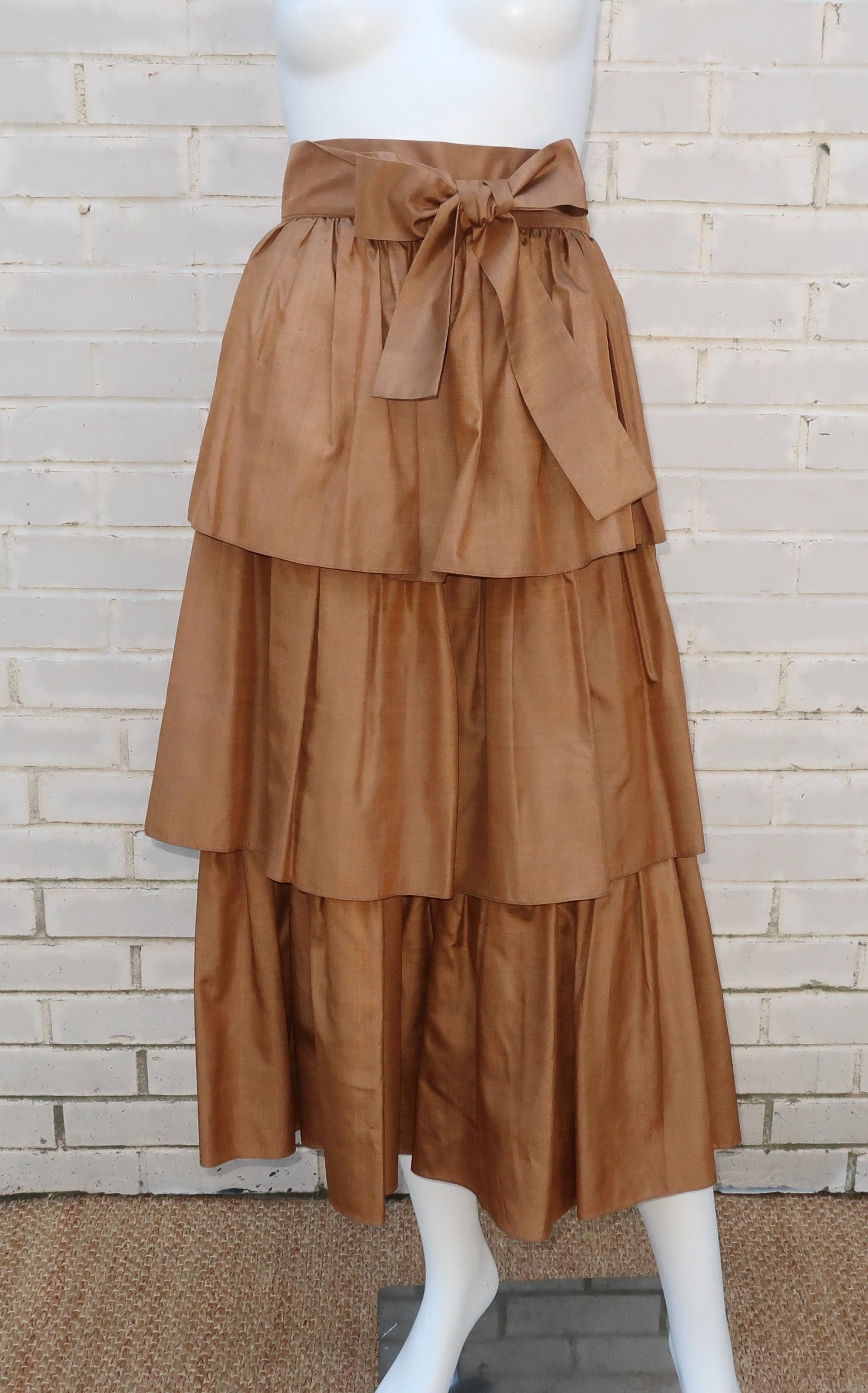 Only Yves Saint Laurent could make dressing like a 'peasant' something glamorous and absolutely desirable.  This raw silk tiered skirt is a lovely feminine design topped with a coordinating sash belt and hidden pockets in the first tier.  It zips