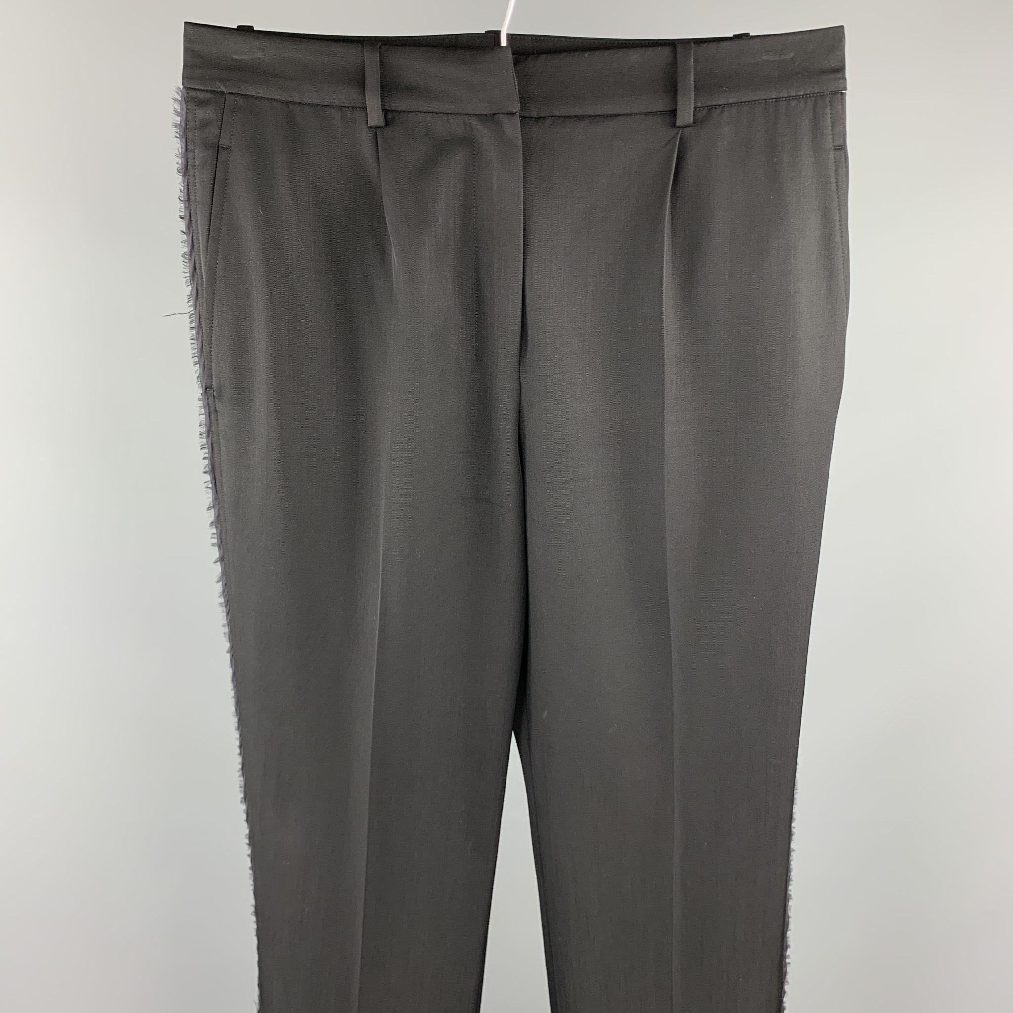 YVES SAINT LAURENT Rive Gauche dress pants comes in a black wool featuring a pleated style, raw edges, and a zip fly closure. Made in France.

Very Good Pre-Owned Condition.
Marked: F 38
Original Retail Price: $990.00

Measurements:

Waist: 30 in.