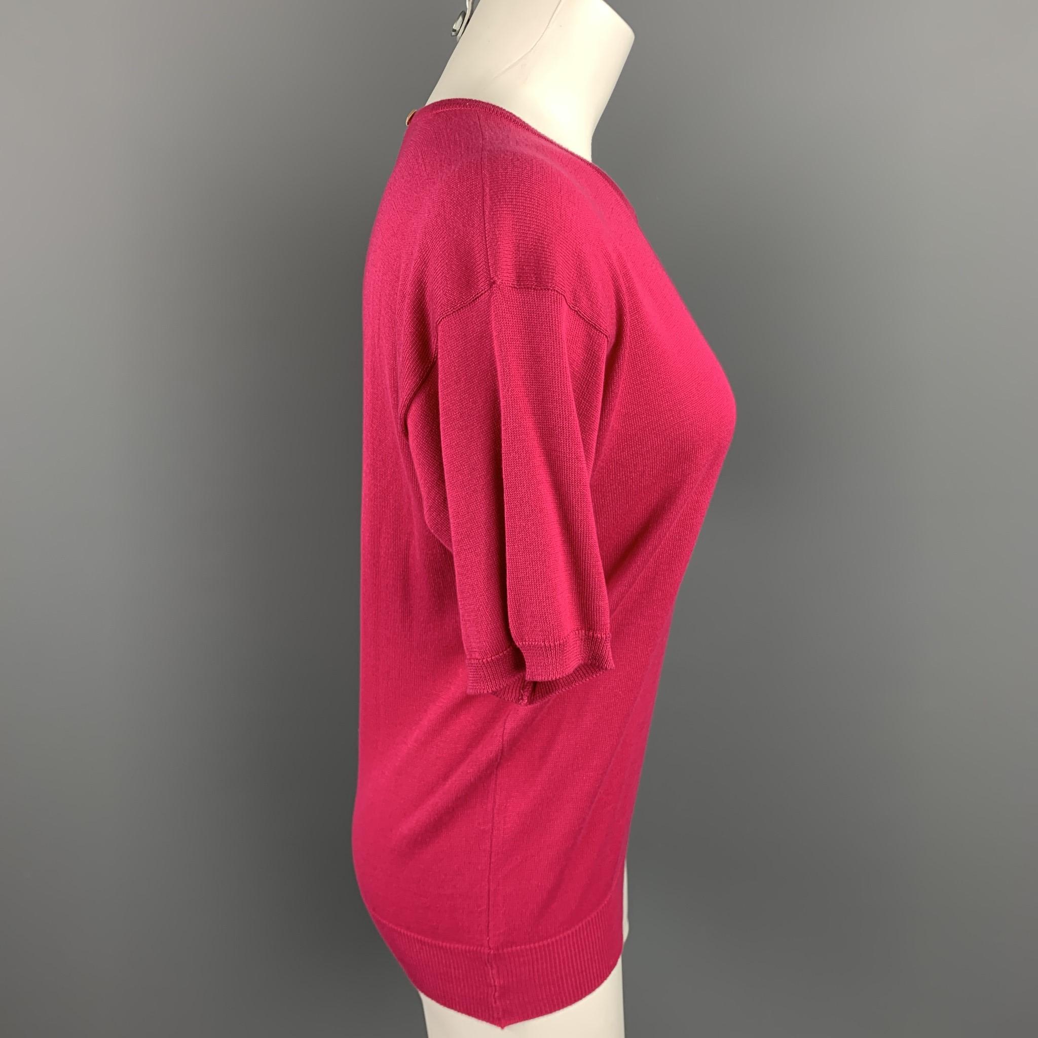 YVES SAINT LAURENT Rive Gauche sweater comes in a fuchsia cotton featuring a crew-neck and back button detail. Made in Scotland.

Good Pre-Owned Condition.
Marked: 36

Measurements:

Shoulder: 19 in. 
Bust: 34 in. 
Sleeve: 8.5 in. 
Length: 24 in. 