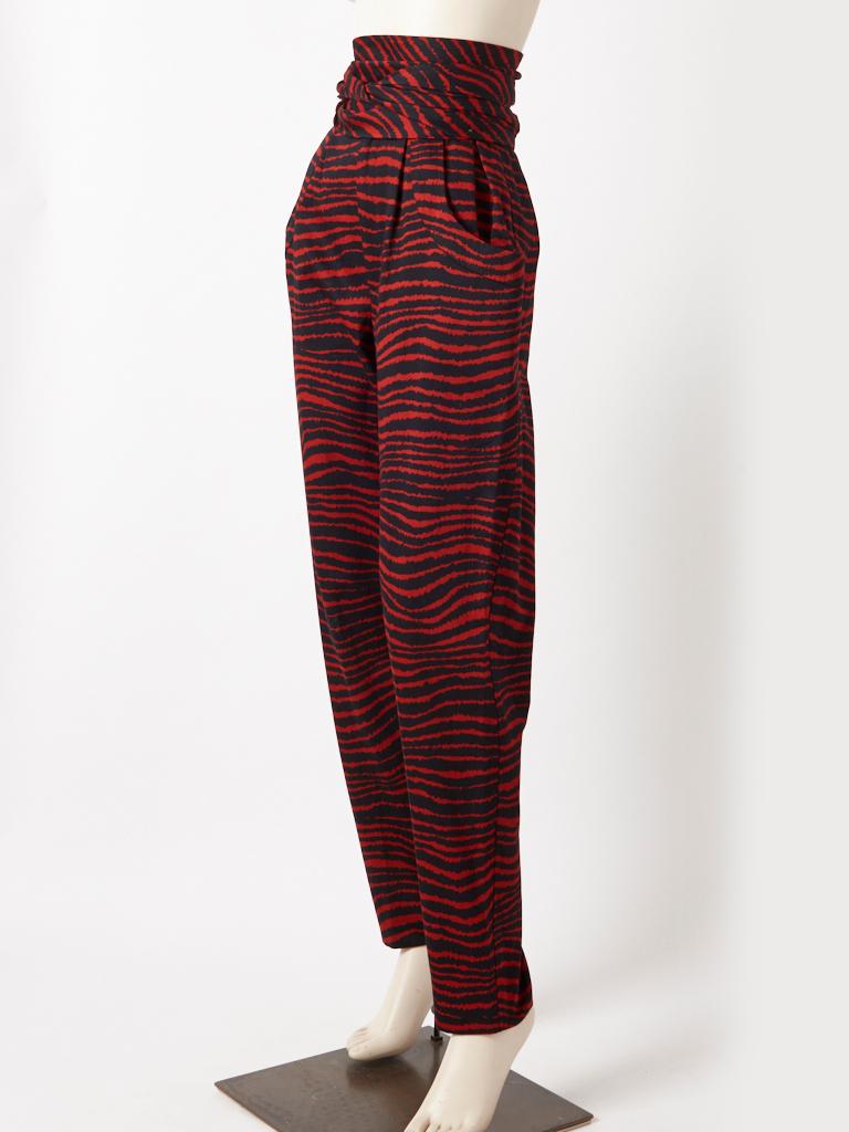 Yves Saint Laurent, Rive Gauche, deep red and black tiger pattern, cotton, tapered pant,  having a fly front zipper closure,  gentle pleating at the hips, hip pockets and a wide sash/belt.  