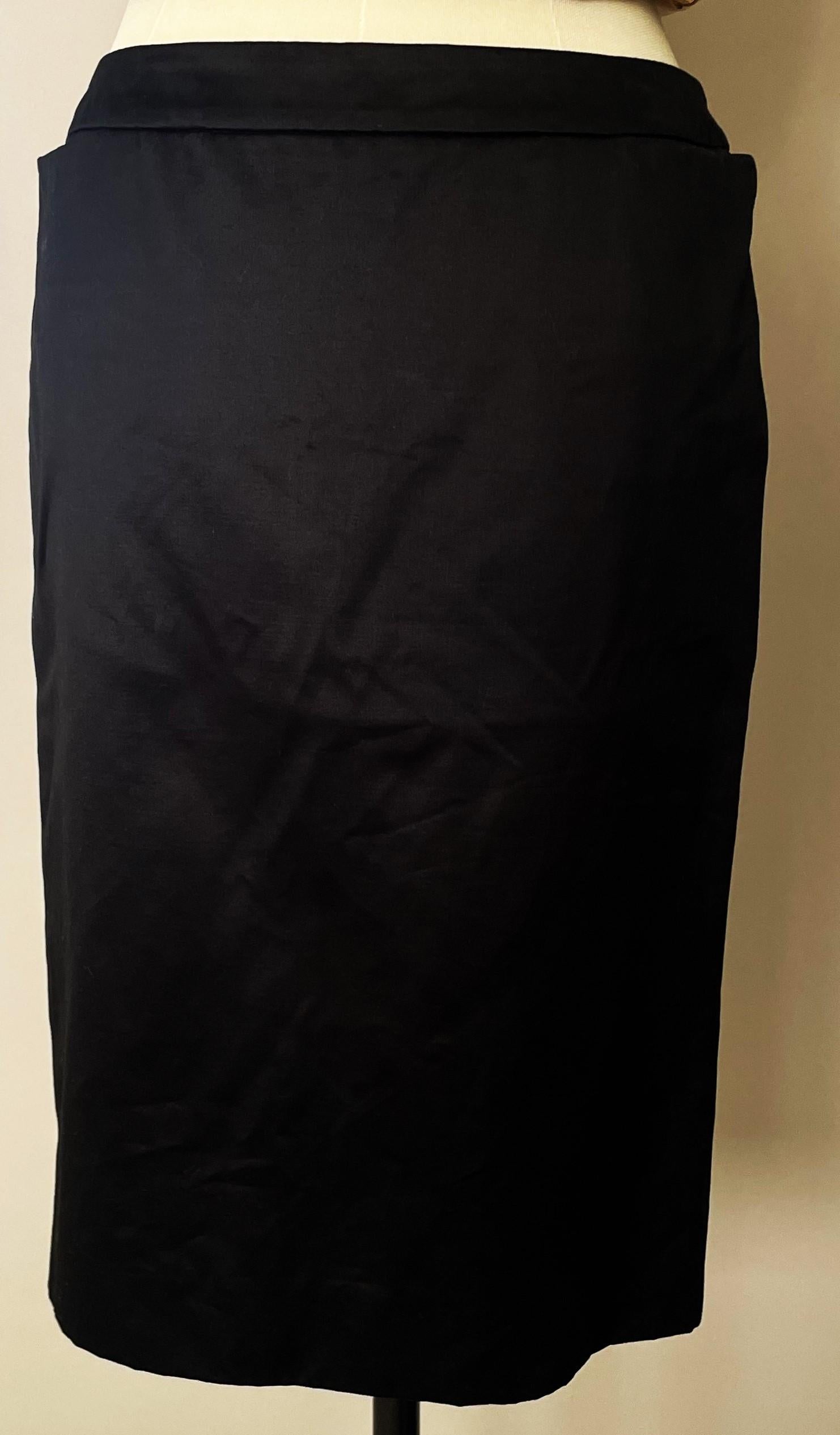 The Yves Saint Laurent Vintage 90s Black Sateen Classic Short Skirt with Pockets is a standout piece from YSL’s celebrated 1990s collections. 
This skirt features a classic silhouette, known for its timeless appeal and ability to enhance the natural