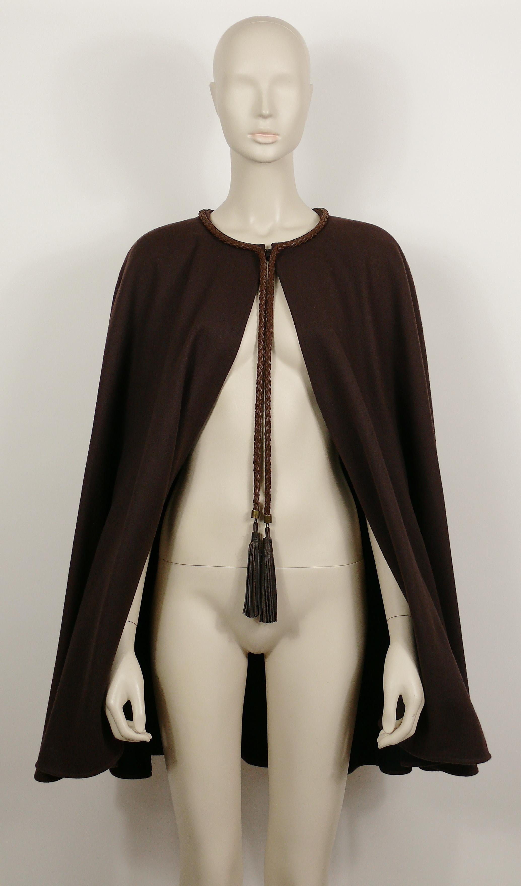 YVES SAINT LAURENT Rive Gauche vintage brown cape featuring leather tassels and breaded trim.

Single breast buttoning.
Antiqued bronze toned hardware.
Fully lined.

Label reads SAINT LAURENT Rive Gauche Paris.
Made in France.

Size tag reads :