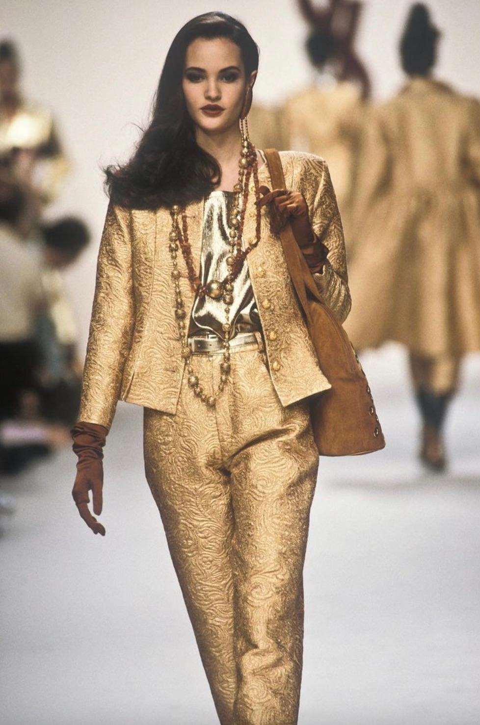 Dieser Vintage-Anzug von Yves Saint Laurent aus dem Jahr 1991 besteht aus einer luxuriösen Jacke aus Goldbrokat und einem passenden Bleistiftrock mit hoher Taille. Die taillierte Jacke hat einen Rundhalsausschnitt, verzierte Goldknöpfe und einen