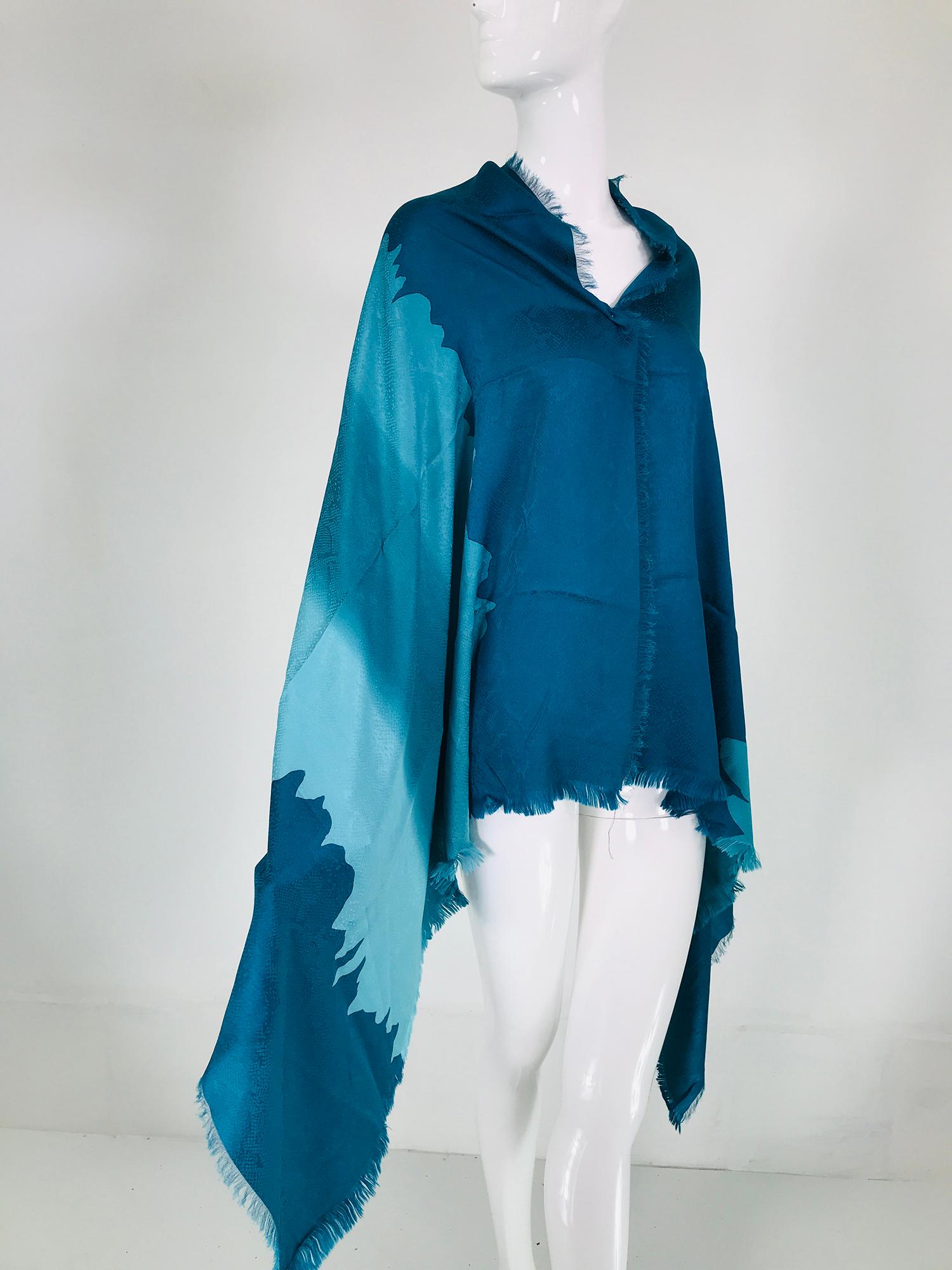 Yves Saint Laurent Rive Gauche X long rectangle, silk jacquard shawl/scarf with self fringe on 4 sides.
The design is snake skin in shades of aqua & turquoise blue, a beautiful scarf with many uses, in excellent condition, barely, if ever used. 34