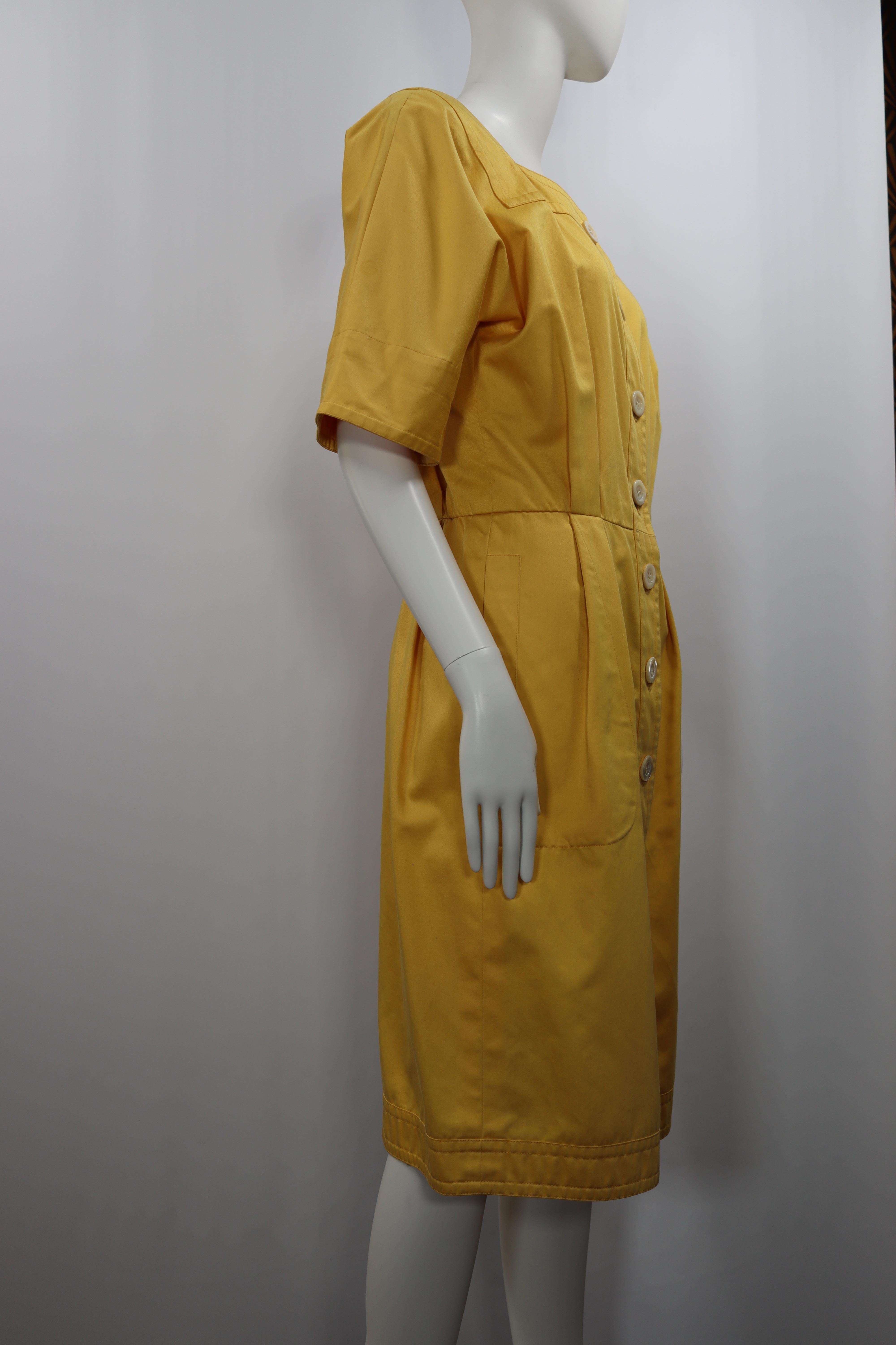 Good condition, shows some signs of use and wear as light stains in the back of the dress.
Yellow elegant cotton dress with eight white button
Height 104 cm / 41