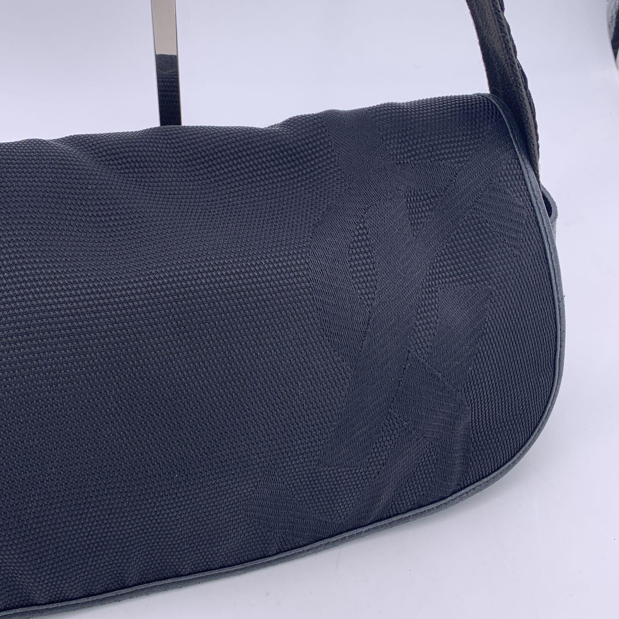 Yves Saint Laurent Black canvas and leather shoulder bag. the bag features a jacuqrd YSL logo on the flap, flat strap, top flap with magnetic closure and 1 side zip pocket inside. 'YVES SAINT LAURENT - Rive Gauche' tag inside (with 'Made in Italy'