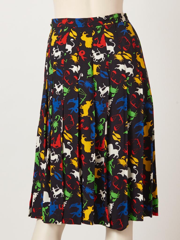 Yves Saint Laurent Rive Gauche,  multi tone, Zodiac signs pattern,  on a black ground, crepe skirt having stitched down pleating from the waist to the hem and loose pleats from the hip down to the hem. C late 70's.