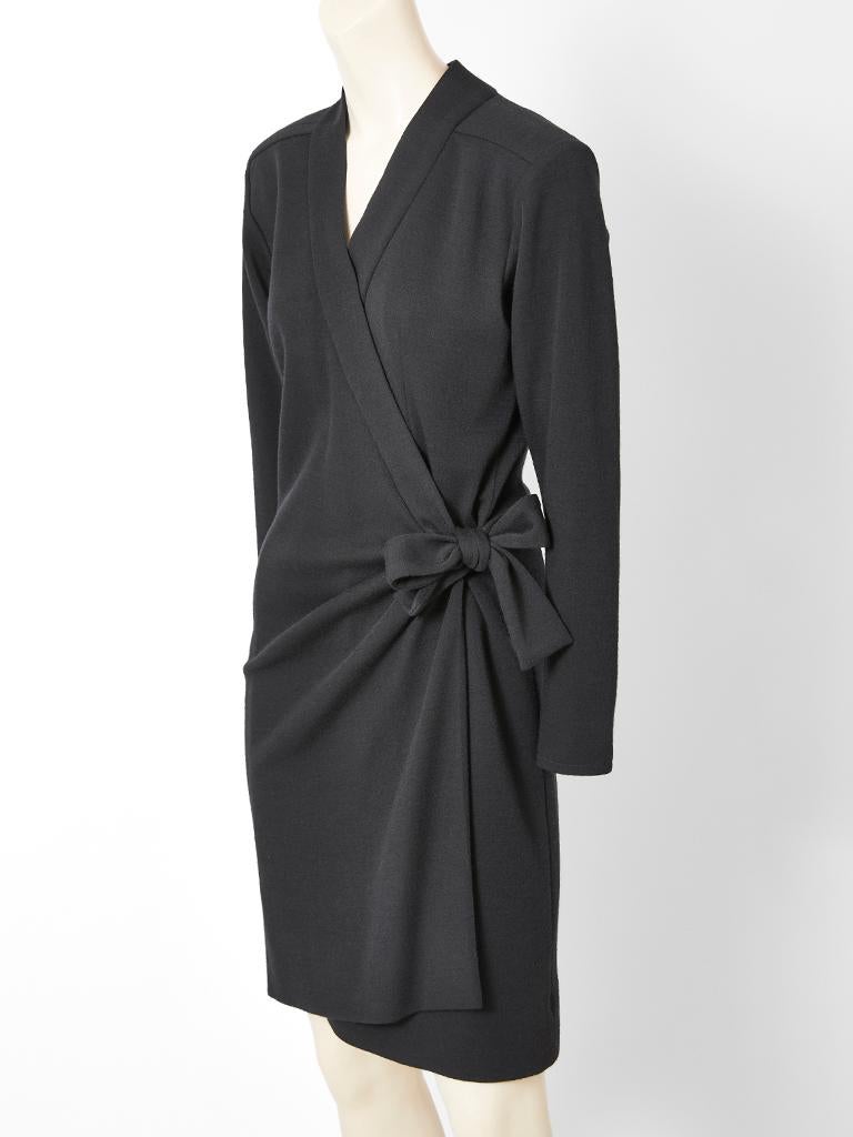 Yves Saint Laurent, Rive Gauche, black, wool jersey knit, V neck, long sleeve, wrap dress having soft gathering at the hip with a tie detail that can be made into a bow. 