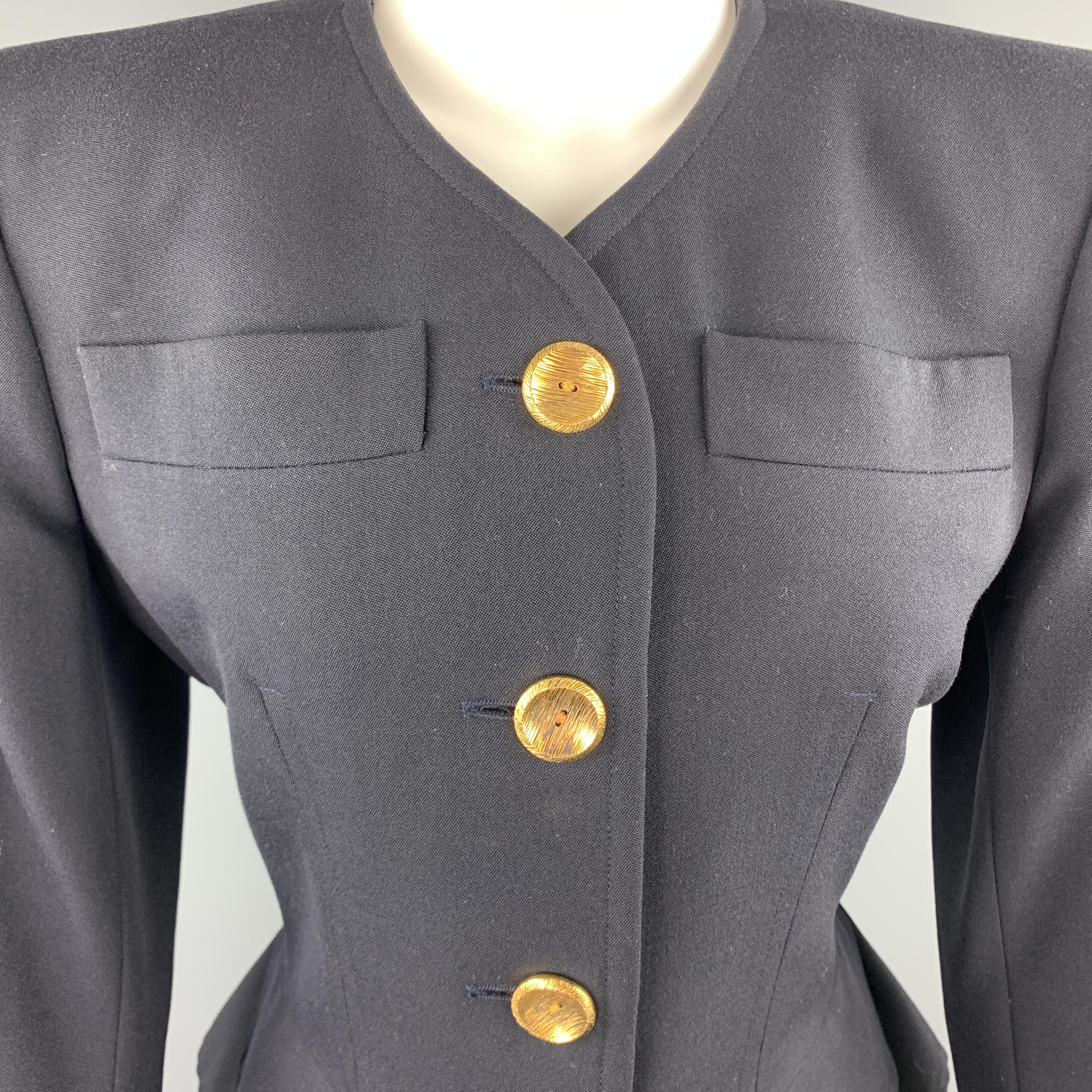 Vintage YVES SAINT LAURENT Rive Gauche blazer comes in navy wool with a collarless V neck, padded shoulders, gold tone buttons. Made in France.

Excellent Pre-Owned Condition.
Marked: FR 38

Measurements:

Shoulder: 16 in.
Bust: 38 in.
Sleeve: 23