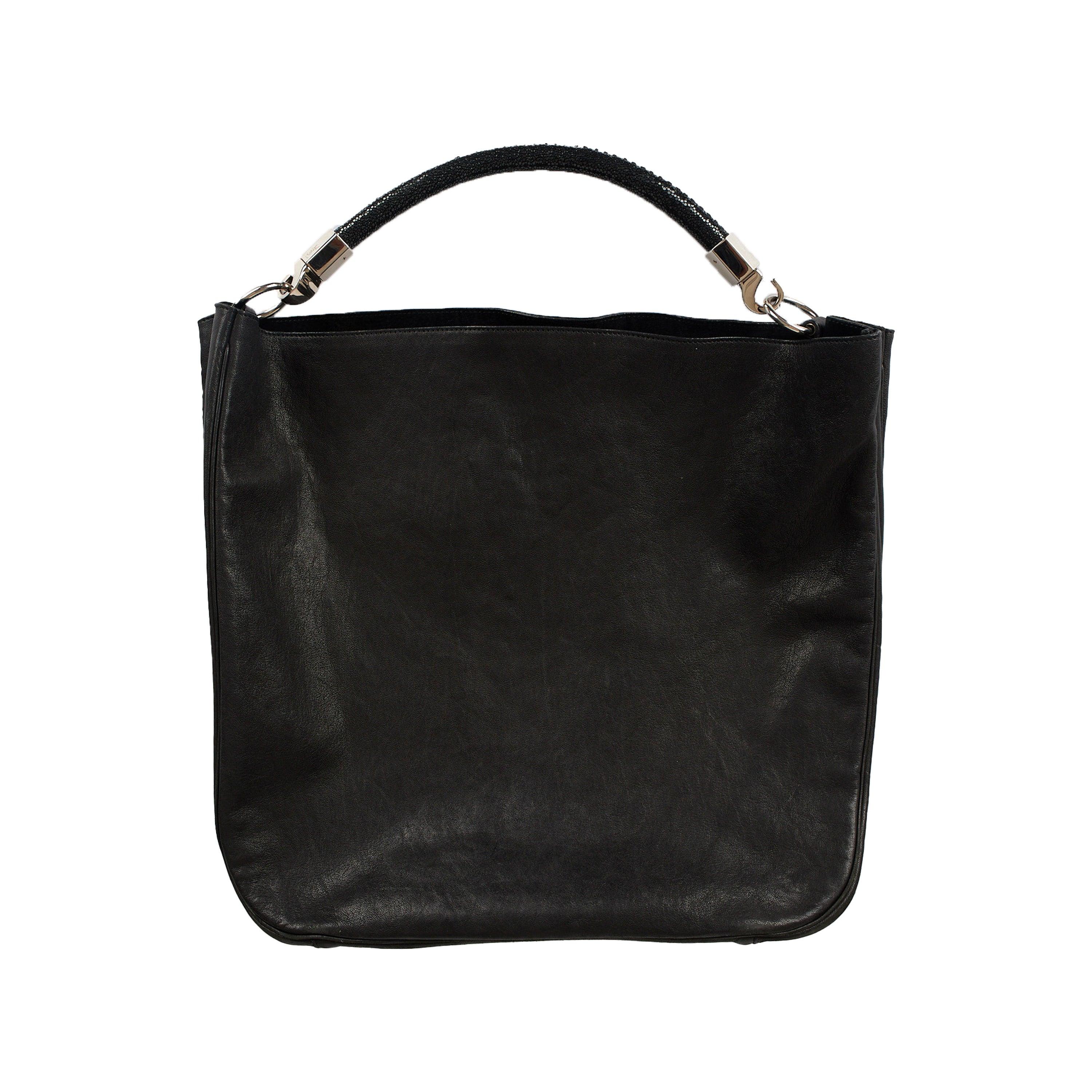 This Yves Saint Laurent Roady Hobo Bag, crafted in lambskin leather, is perfect for everyday use. It features a black leather with crystal rolled top handle and silver-tone hardware with embossed YSL logo detail. The interior offers one main