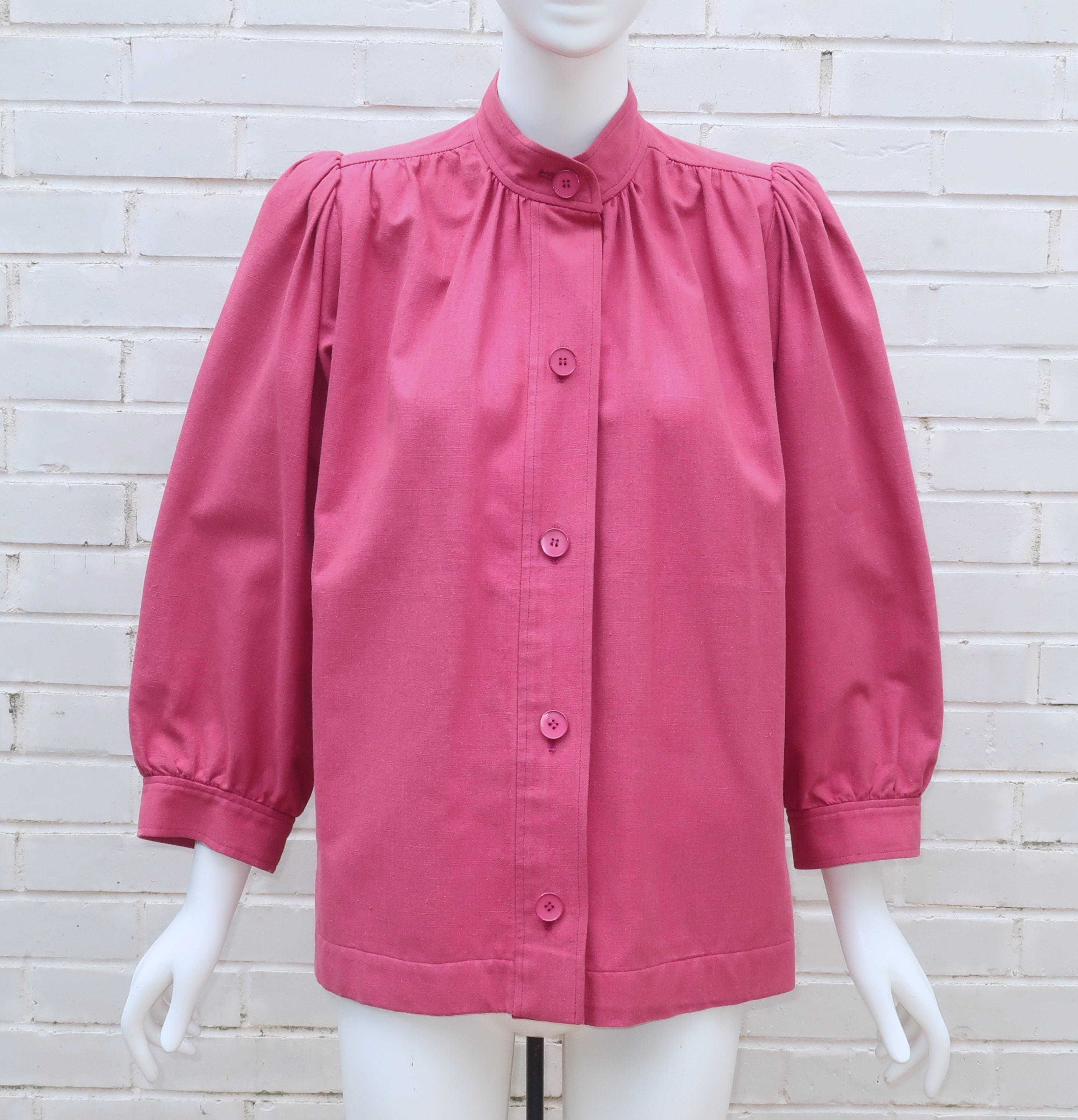 1970's Yves Saint Laurent rosey pink cotton canvas jacket with an artist's smock style including pleats at the shoulder, blouson sleeves, collarless neckline, side pockets and button front.  The strong shoulders enhanced with pads are reminiscent of