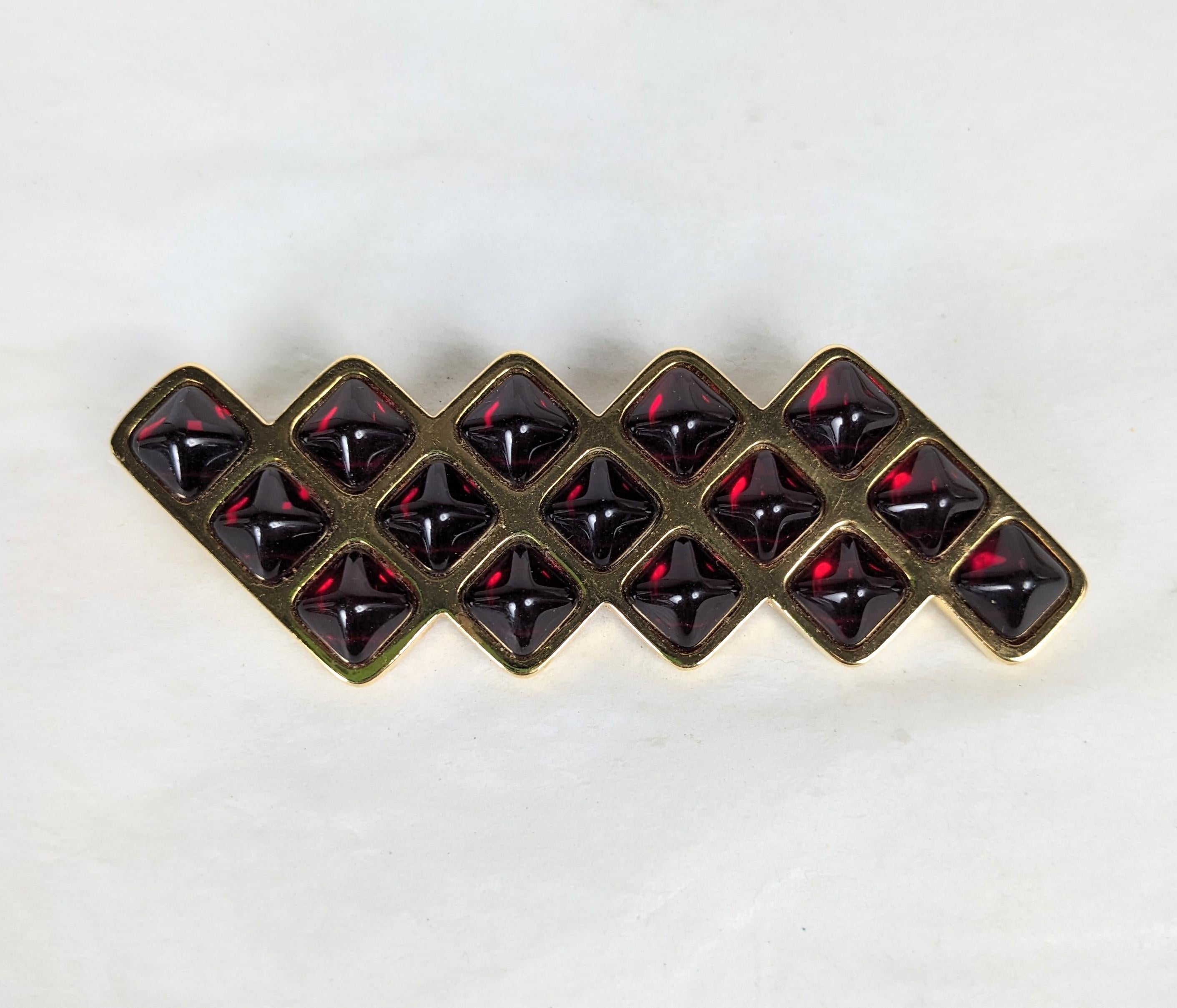Striking Yves Saint Laurent Ruby Bullet Cab Brooch from the 1990's. Made by Maison Goossens in gilt metal in a Deco style design with square red bullet cabs. 3.25 x 1