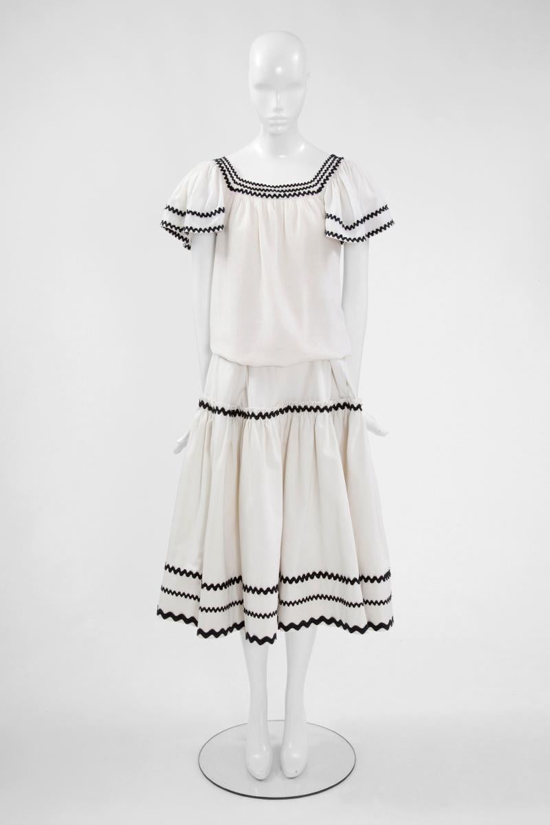 Iconic runway peasant ensemble from the more iconic 1977 YSL Spring-Summer ready-to-wear collection ! While the ruffled tiered skirt is in white cotton poplin, the matching short-sleeved top is made of a dreamy light cotton gauze. Both pieces are