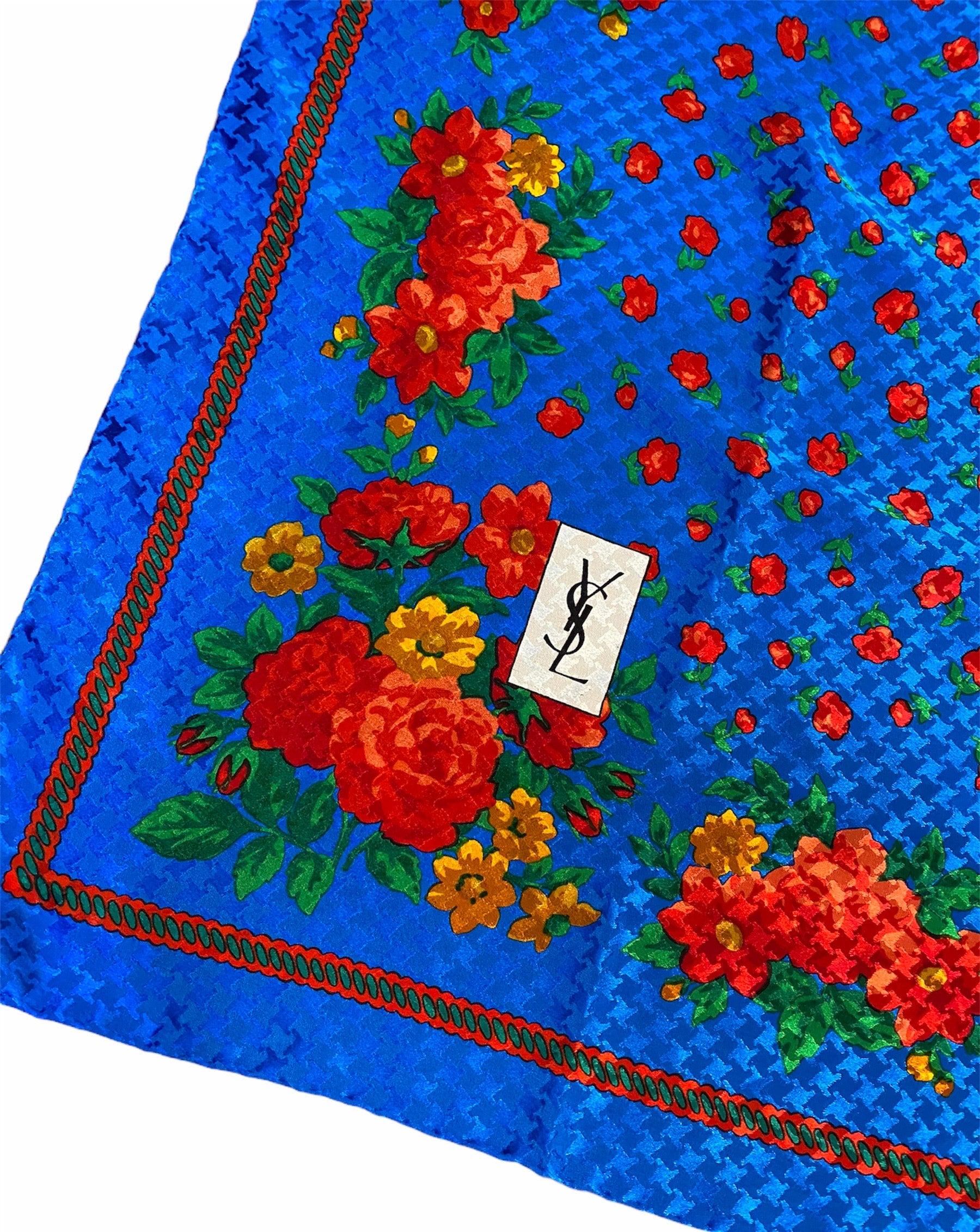 Vibrant scarf from YSL’s iconic 1976 “Russian Collection”. Bright blue with a houndstooth jacquard and a traditional pavlova posad red floral print. Hand rolled edges. Bright and happy. Excellent condition.

Additional
