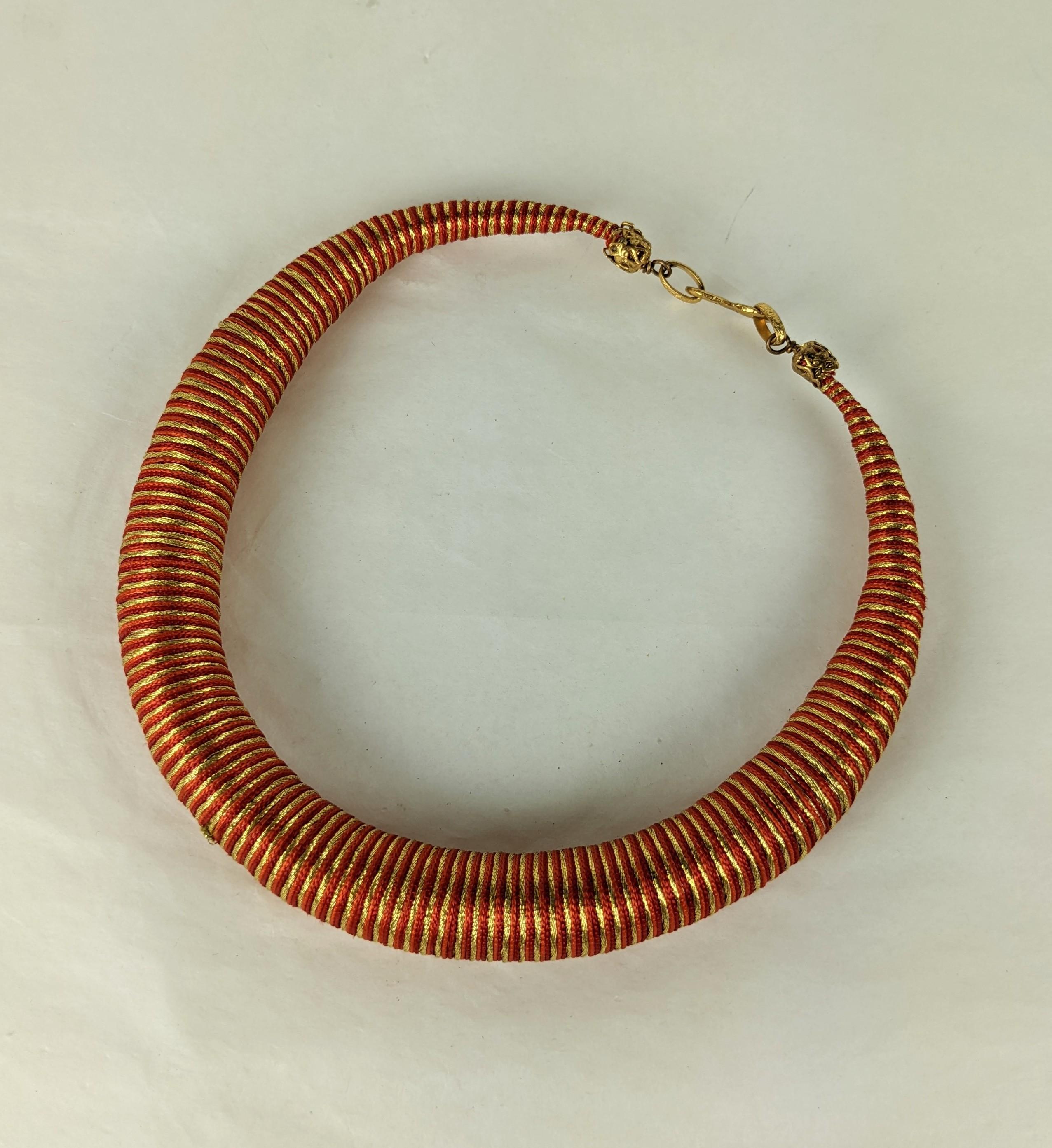 Rare Yves Saint Laurent  Russian Collection torque necklace from Fall-Winter 1976 Haute Couture collection. Deceptively constructed with a soft core tightly wrapped gold metallic, red and orange silk soutache passementerie cord, Signature Yves Saint