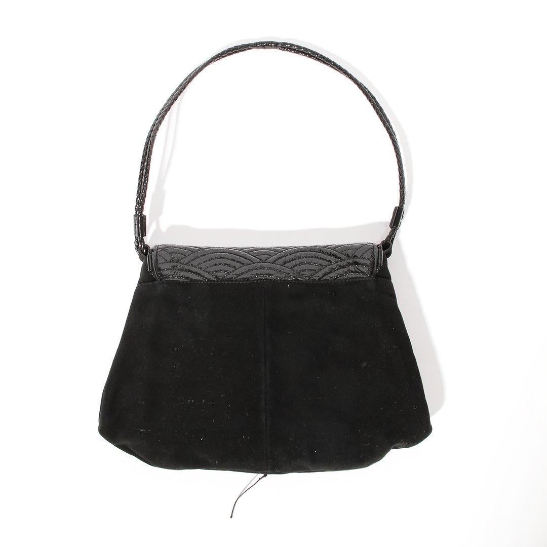 Shoulder bag by Yves Saint Laurent
Black 
Suede
Patent leather top flap 
Braided faux leather strap
Black large circular stone embellishment on front 
White small stone embellishment on front
Open sack interior- no extra interior pockets
Magnetic