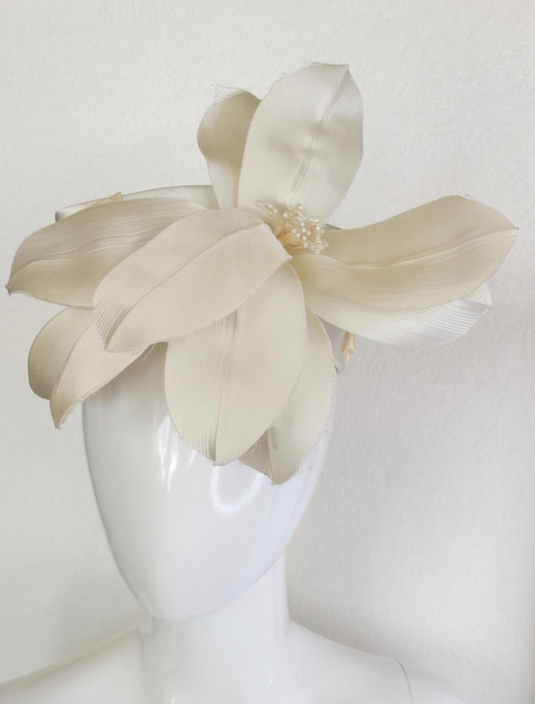 Express yourself with the most beautiful head piece created by Yves Saint Laurent. Made from silk this head piece has a large silk flower creating such a romantic look. Head piece has an open top, small silk  bows attached throughout. Fits a size xs