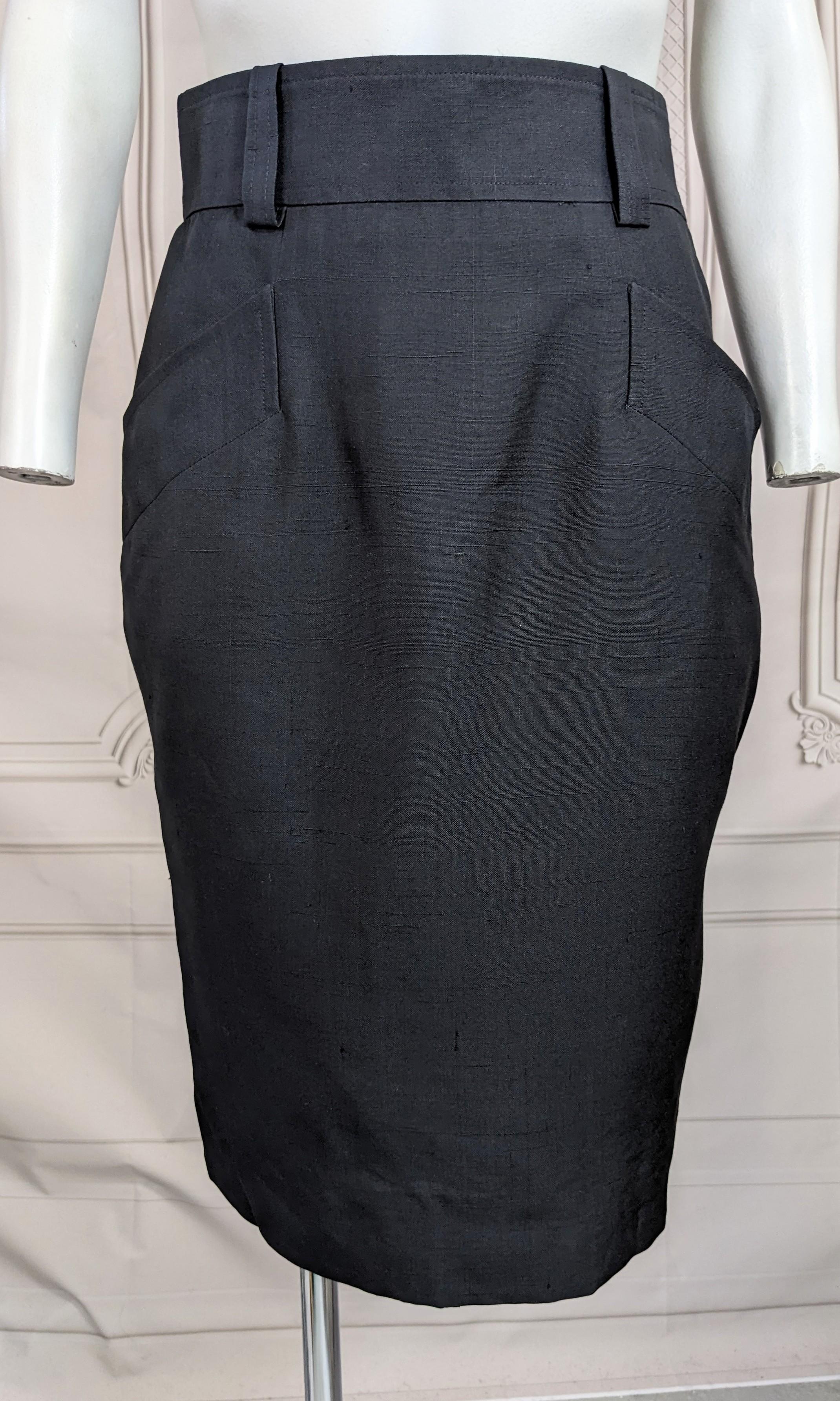 Yves Saint Laurent Silk Pencil Skirt from the 1990's. Classic shape with large angled pockets and belt loops. Black raw silk fully lined with side zip entry. 1990's France. Size 36 Vintage. 
