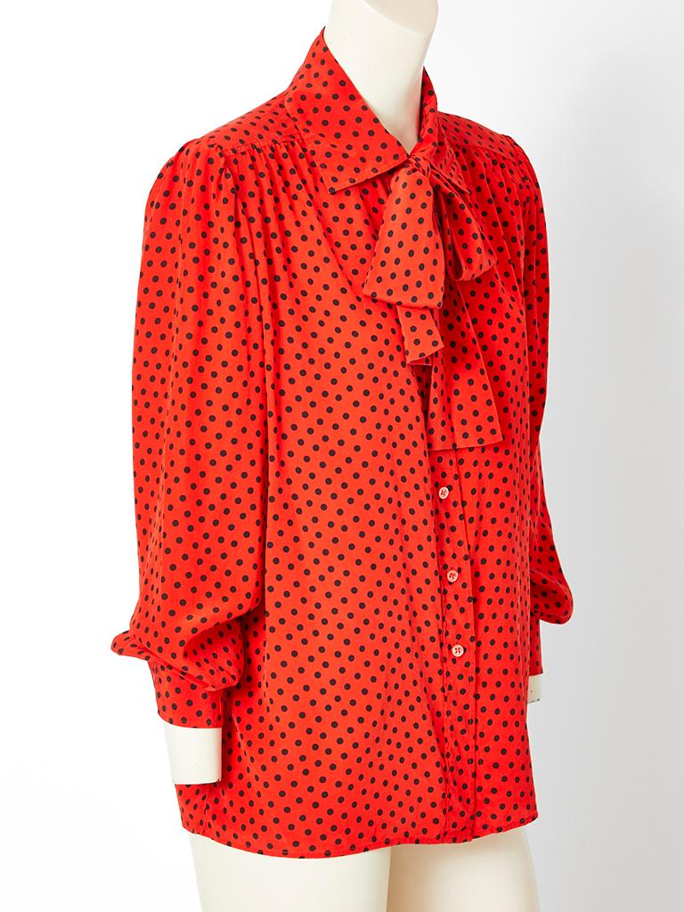 Yves Saint Laurent, Rive Gauche, red, silk crepe, Lavalière blouse having black polka dots, long sleeves and front button closures. Bow can be tied at the neck or worn loosely.