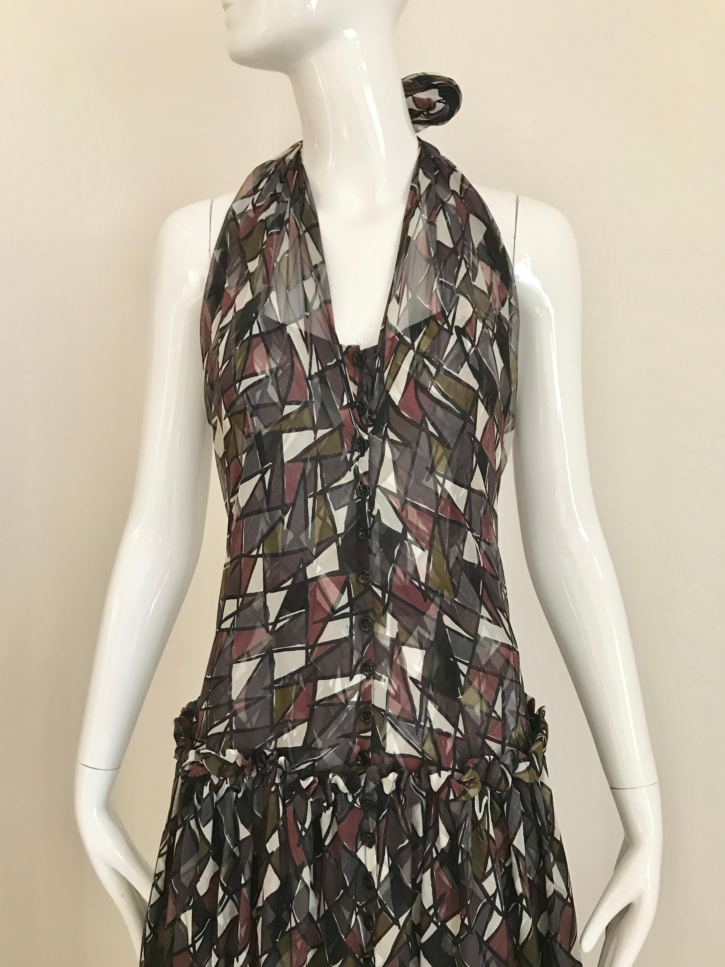 Yves Saint Laurent abstract print in charcoal Grey, red, green and white halter silk dress.
Size XS/2 
Button in the front and drop waist style.
Bust: 31 inches/ Waist: 28 inches / Hip: 34 inches/ Dress length: 50 inches
