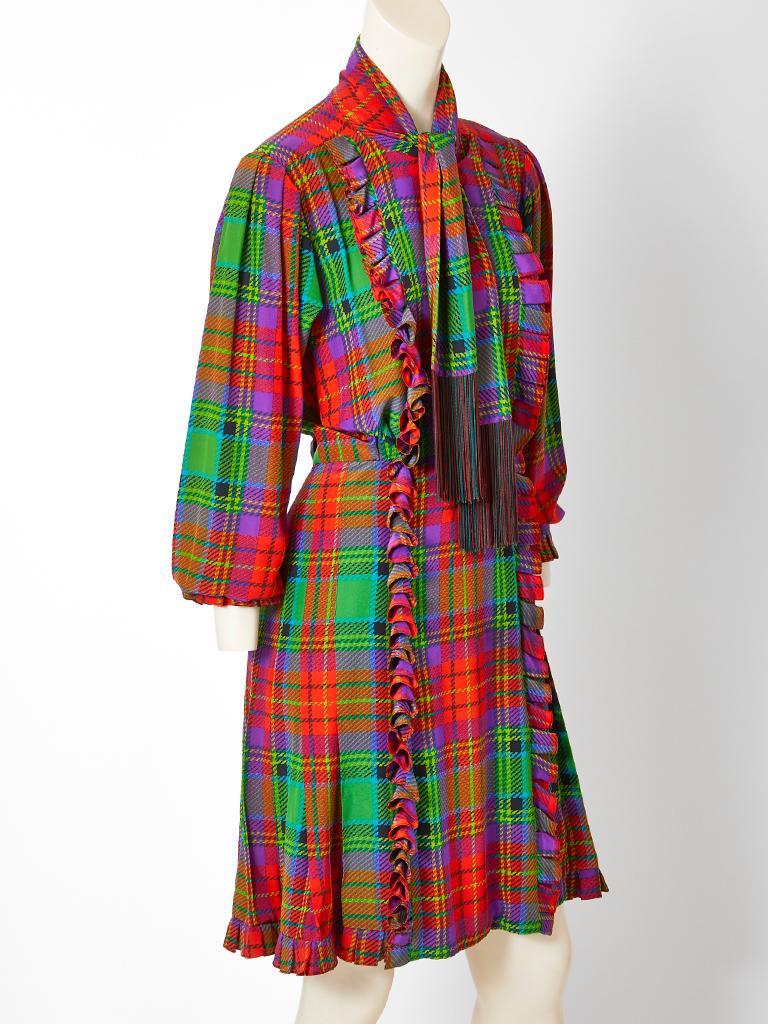 Yves Saint Laurent Rive Gauche, multi tone, silk, tartan plaid, skirt and blouse ensemble. Blouse and skirt both have a vertical ruffle detail. The top has a detachable scarf with a deep fringe. Skirt is like a kilt with a flat front and vertical