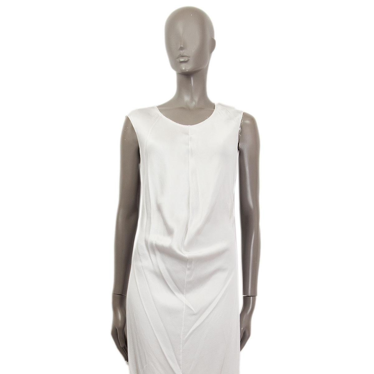 100% authentic Yves Saint Laurent vintage slip dress in light silver silk (100%) with a fitted silhouette. Round neckline, sleeveless , dipped front hemline and slightly stretchy fabric. Has been worn and shows minor imperfections at the lower