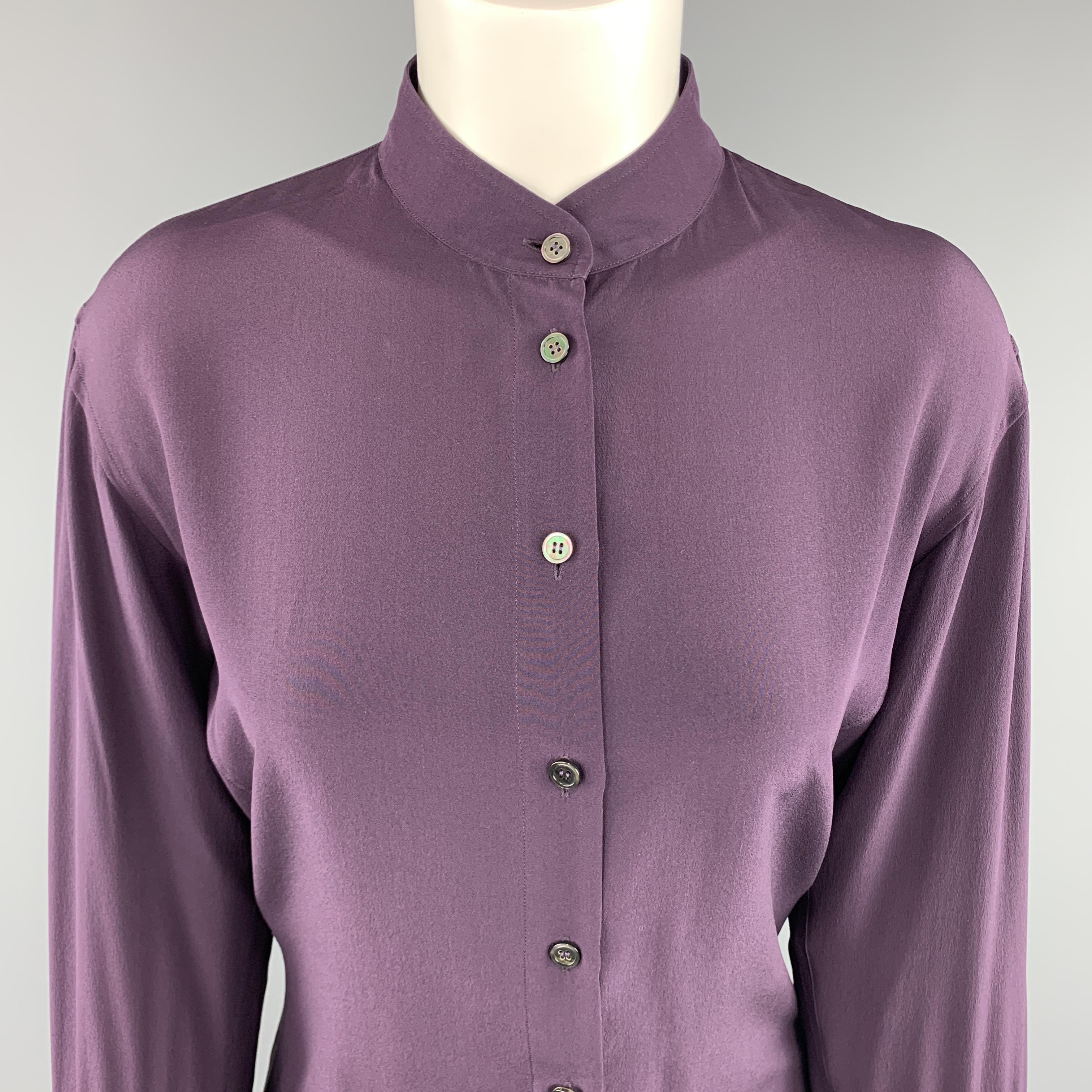 Archive YVES SAINT LAURENT blouse comes in plum purple silk with a band collar and extended ten button cuffs. Made in Italy.

Excellent Pre-Owned Condition.
Marked: (no size)

Measurements:

Shoulder: 18 in.
Bust: 36 in.
Sleeve: 25 in.
Length: 24 in.