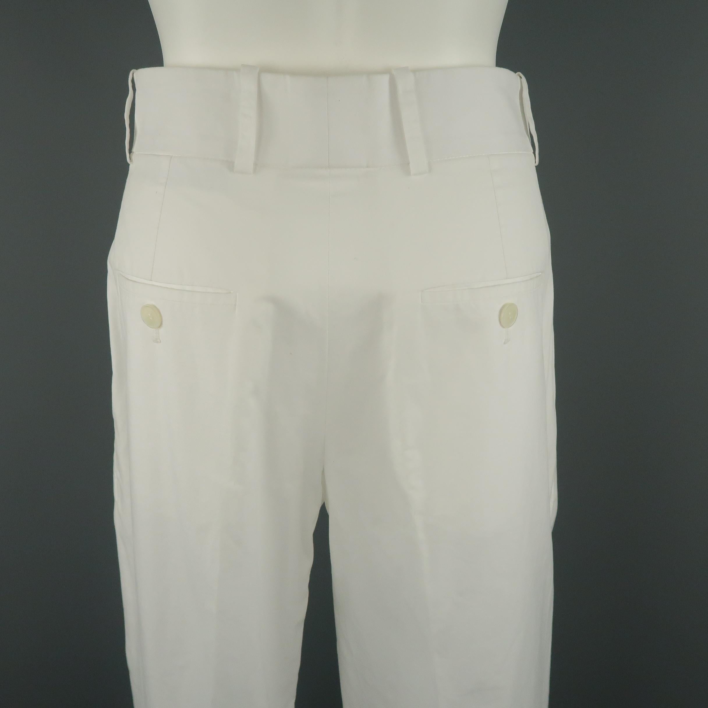 Vintage YVES SAINT LAURENT RIVE GAUCHE pants come in white cotton with a high rise, single pleat front, and wide leg with cuffed hem. Made in France.
 
Very Good Pre-Owned Condition.
Marked: FR 36
 
Measurements:
 
Waist: 29 in.
Rise: 11.5