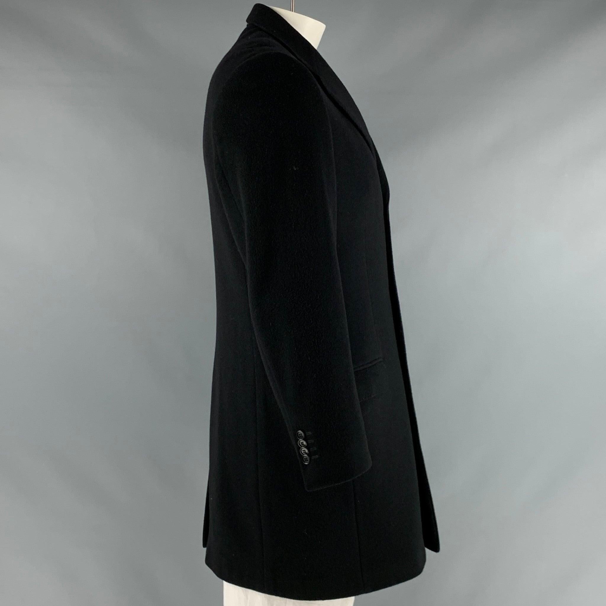 YVES SAINT LAURENT coat
in
a black wool blend fabric featuring a single breasted style, three pockets, and a four button closure.Good Pre-Owned Condition. 

Marked:   IT 52 

Measurements: 
 
Shoulder: 19 inches Chest: 42 inches Sleeve: 24 inches