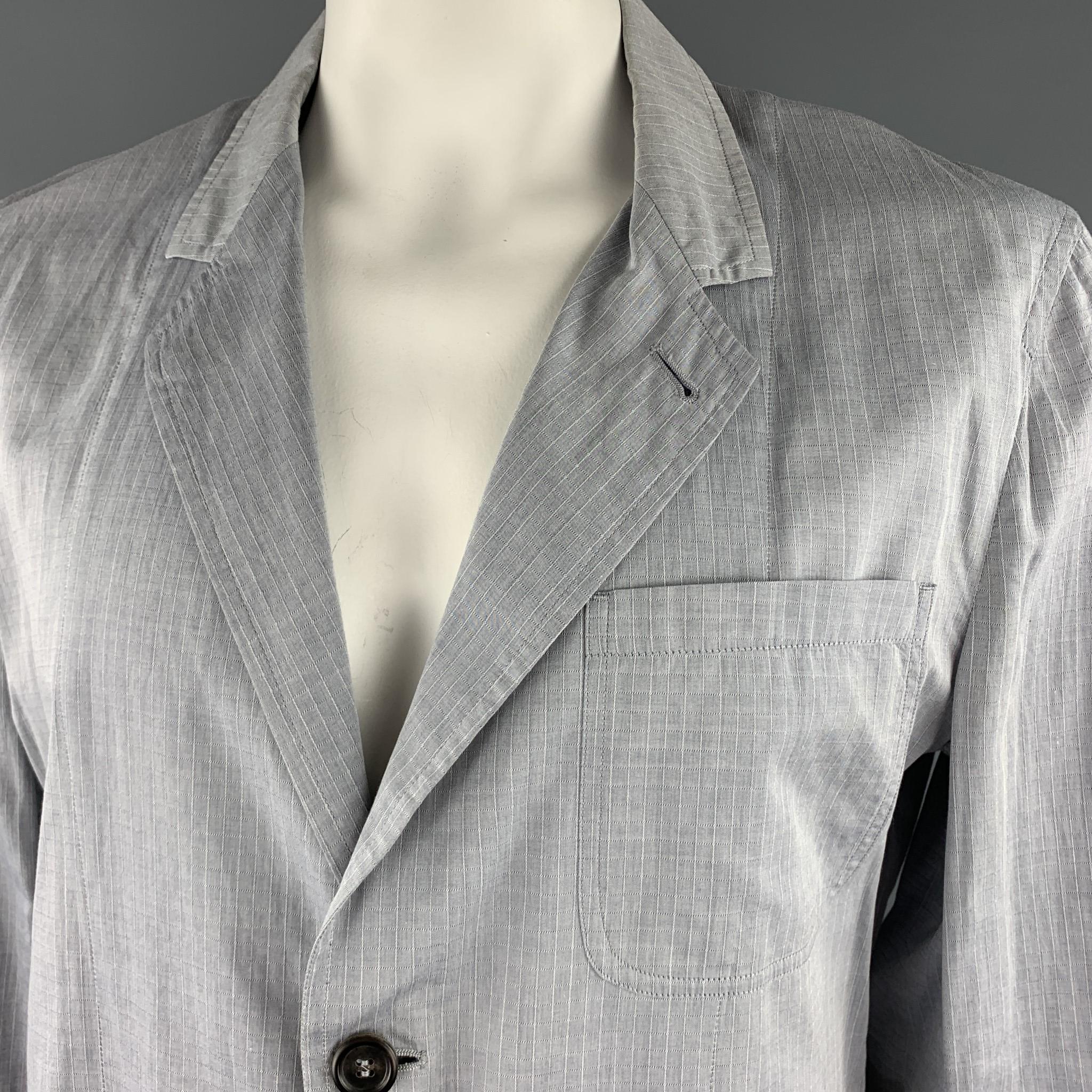 YVES SAINT Laurent light weight summer sport coat comes in light gray windowpane cotton with a notch lapel, single breasted, two button front, and patch pockets. Wear throughout. As-is. Made in Italy.

Fair Pre-Owned Condition. 
Marked: IT