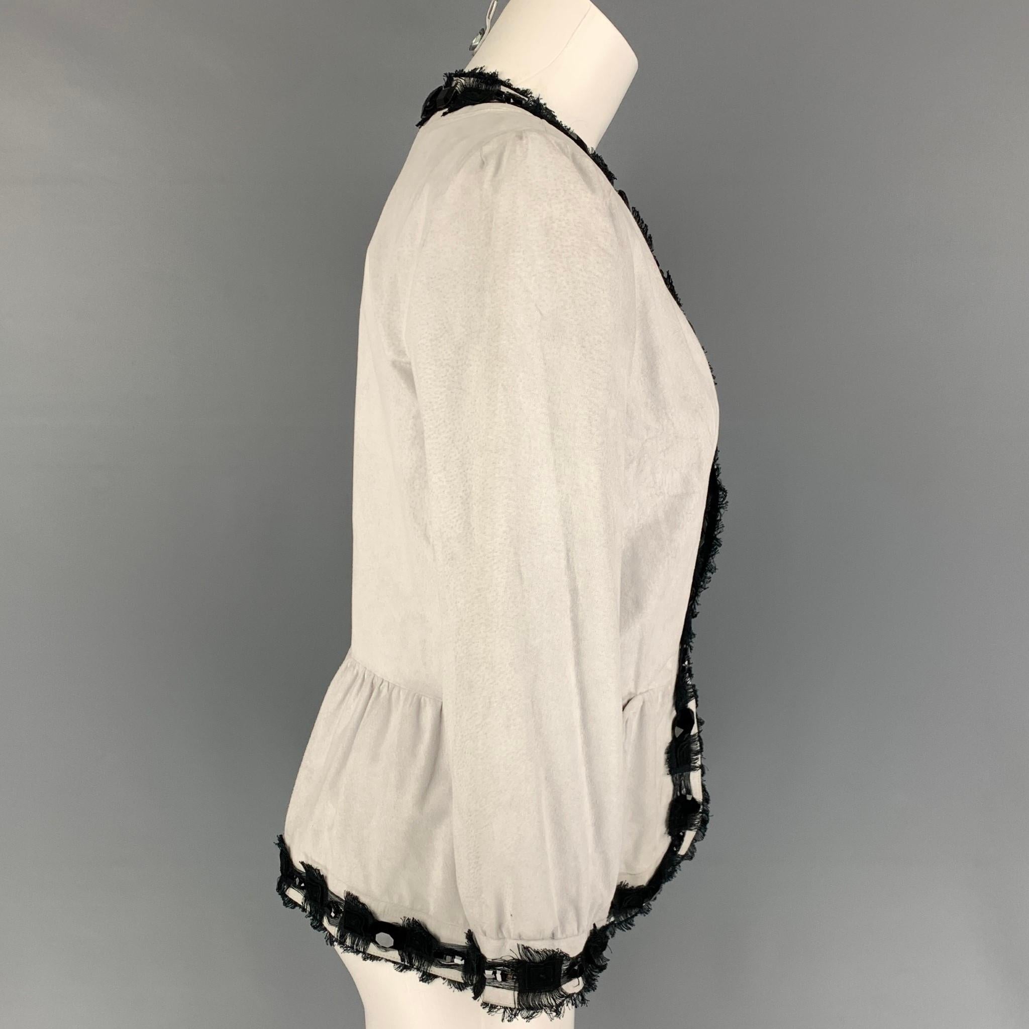 YVES SAINT LAURENT jacket comes in a off white leather with a black linen trim featuring large crystal embellishments, front pockets, and a hook & loop closure. Made in Italy. 

Very Good Pre-Owned Condition.
Marked: 38

Measurements:

Shoulder: 14