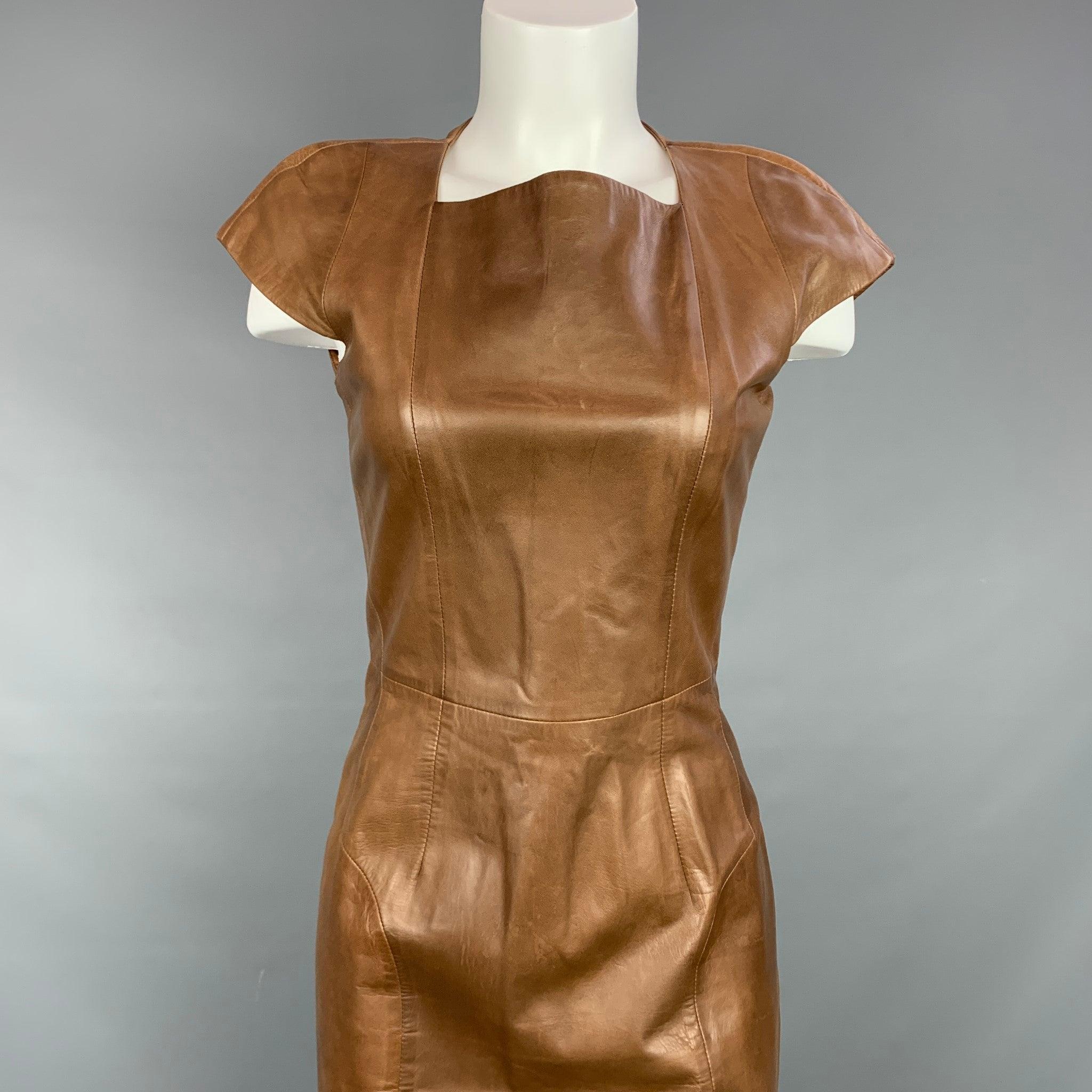YVES SAINT LAURENT dress comes in a tan leather with a full liner featuring a shift style, cap sleeves, top stitching, and a back zip up closure. Made in Italy.
Very Good
Pre-Owned Condition. 

Marked:   38 

Measurements: 
 
Shoulder: 19 inches 