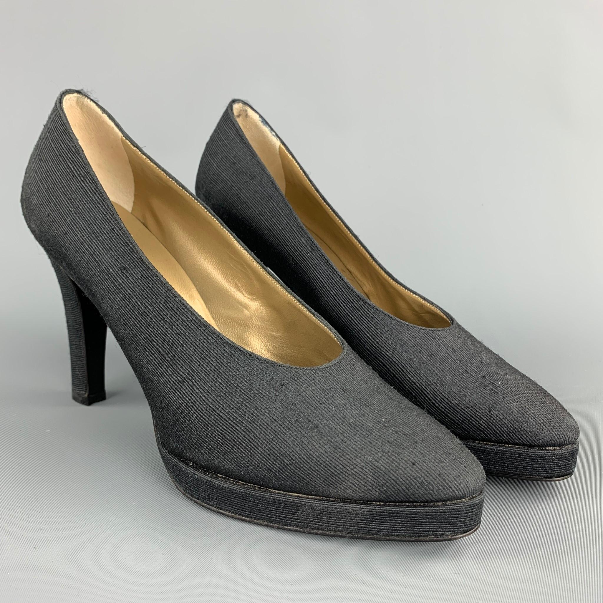 YVES SAINT LAURENT pumps comes in a black textured fabric featuring a platform style, stacked heel, and a wooden sole. Made in Italy.

Very Good Pre-Owned Condition.
Marked: 7 M

Measurements:

Heel: 4 in.
Platform: 0.5 in. 