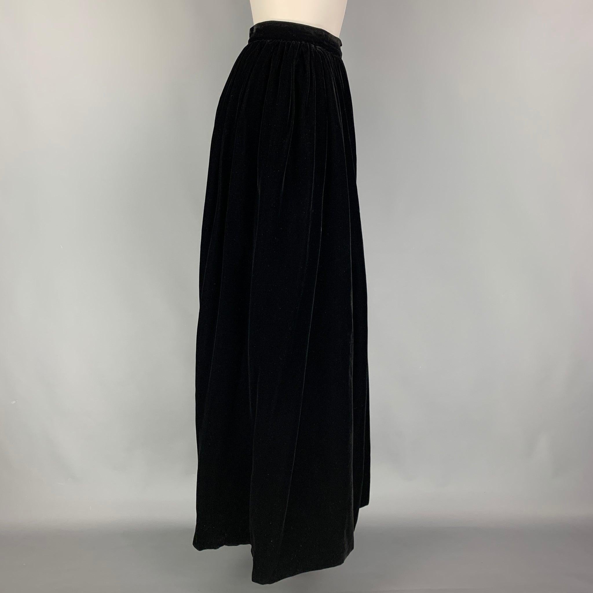 YVES SAINT LAURENT skirt comes in a black rayon featuring a pleated style and a zip up closure. Made in France.
Very Good
Pre-Owned Condition. 

Marked:   44 

Measurements: 
  Waist: 28 inches  Hip: 34 inches  Length: 44 inches 
  
  
 
Reference: